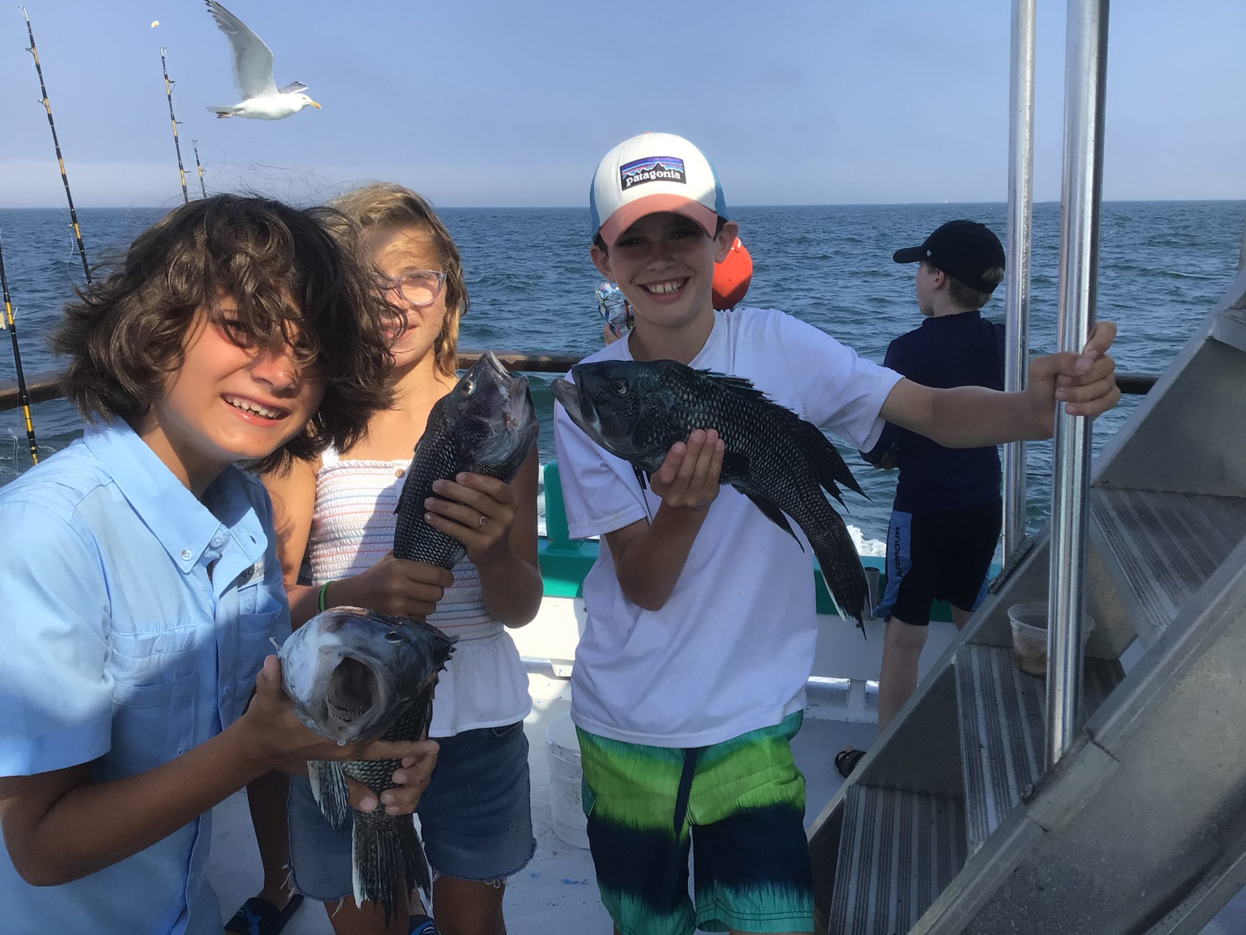 a man and a woman standing on a boat in the water