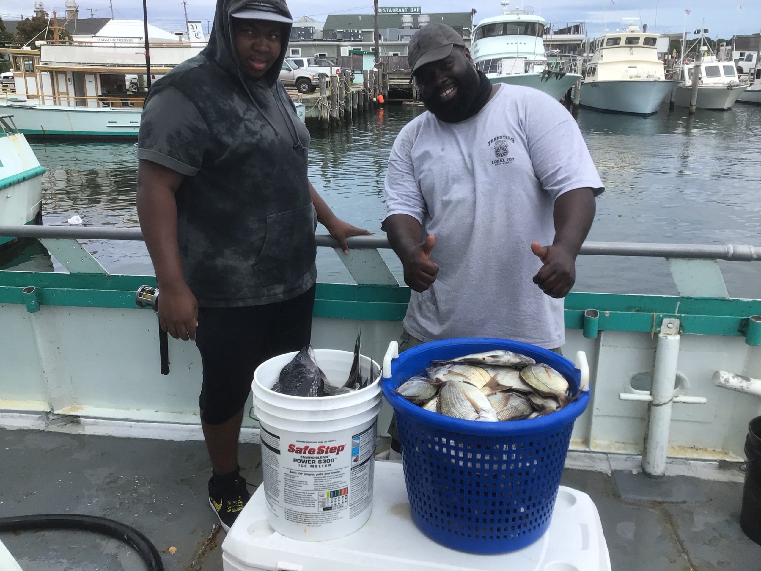 a man holding a fish on a boat