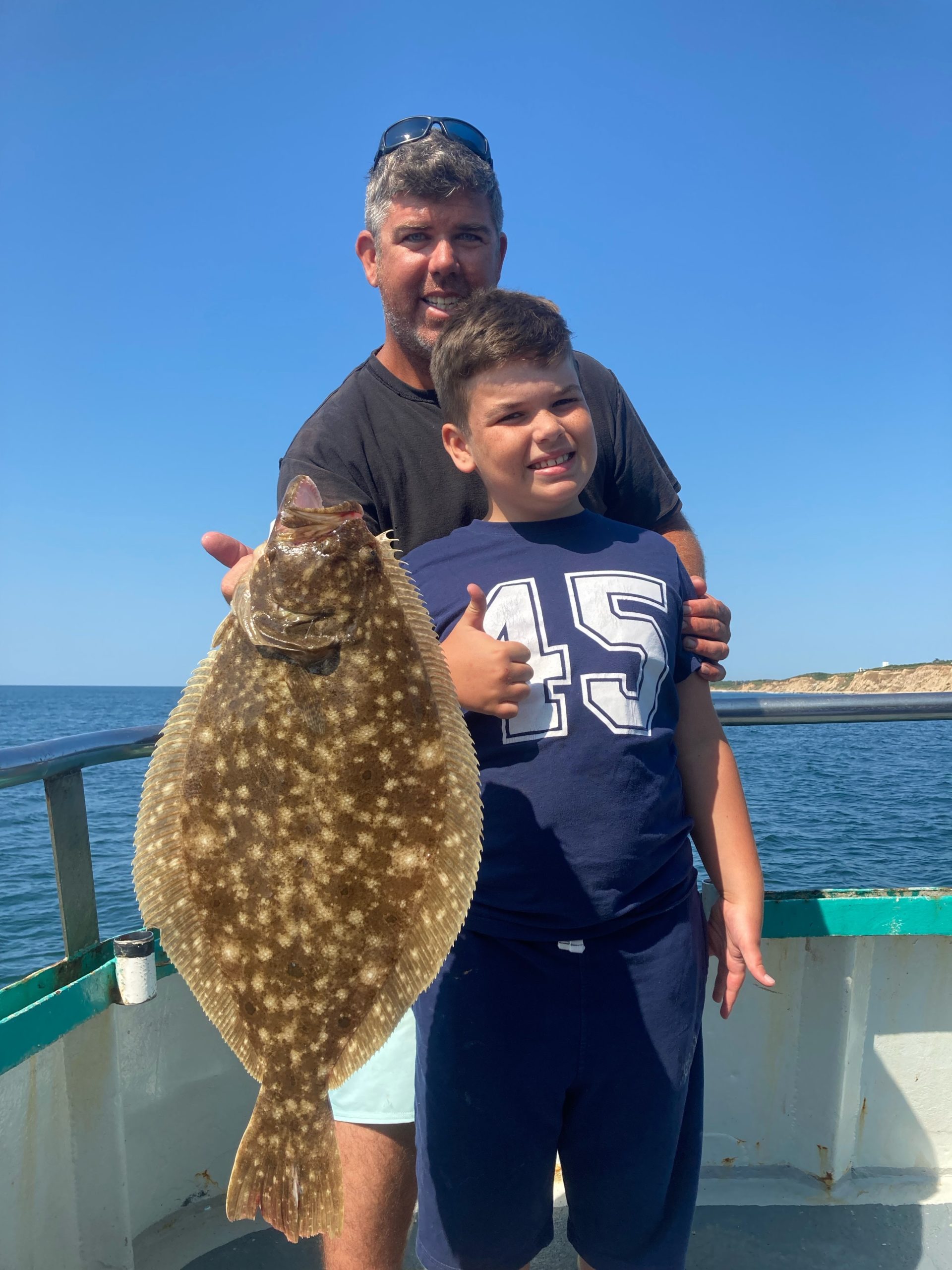 a man holding a fish in the water