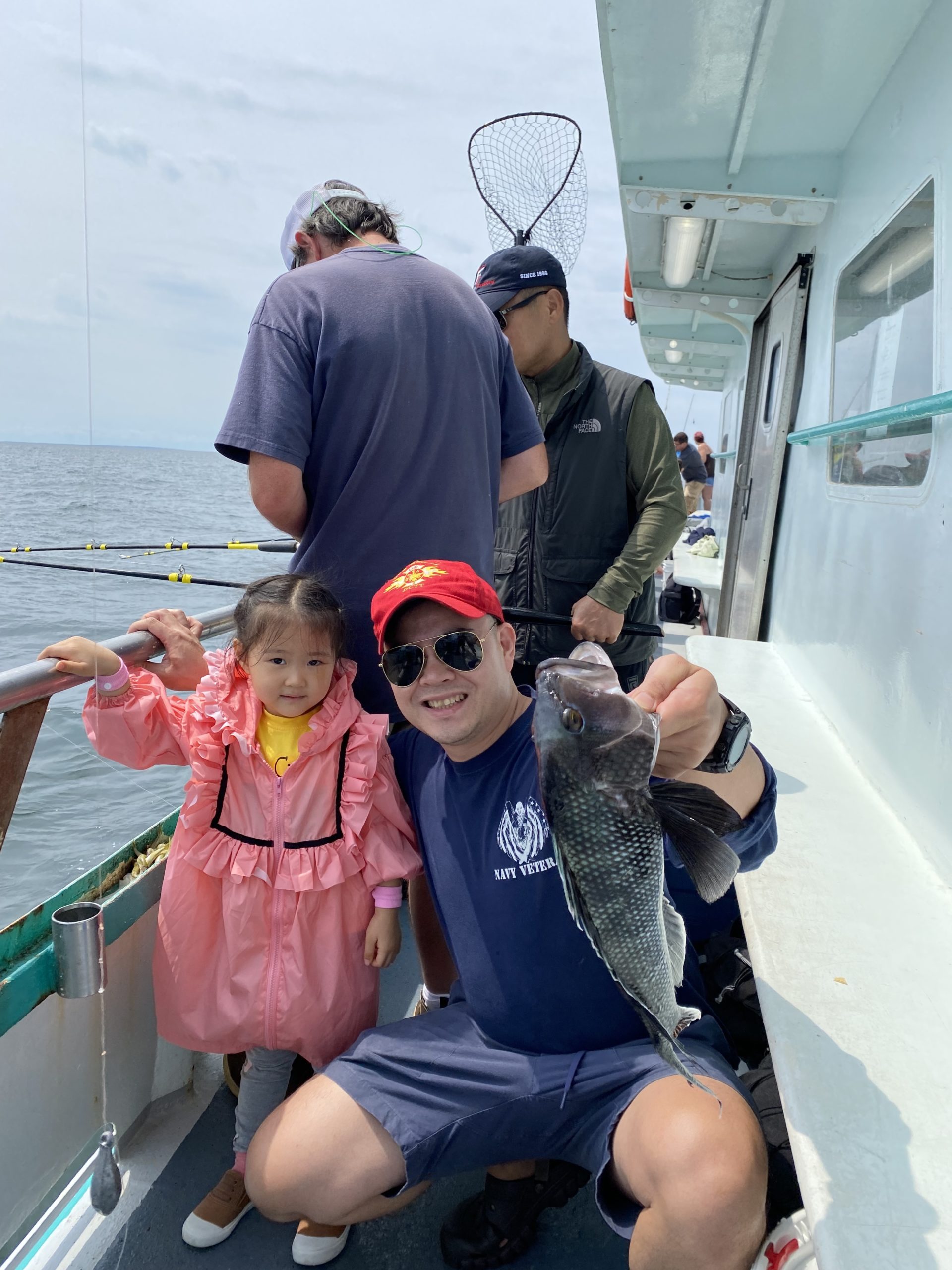 a person holding a fish on a boat