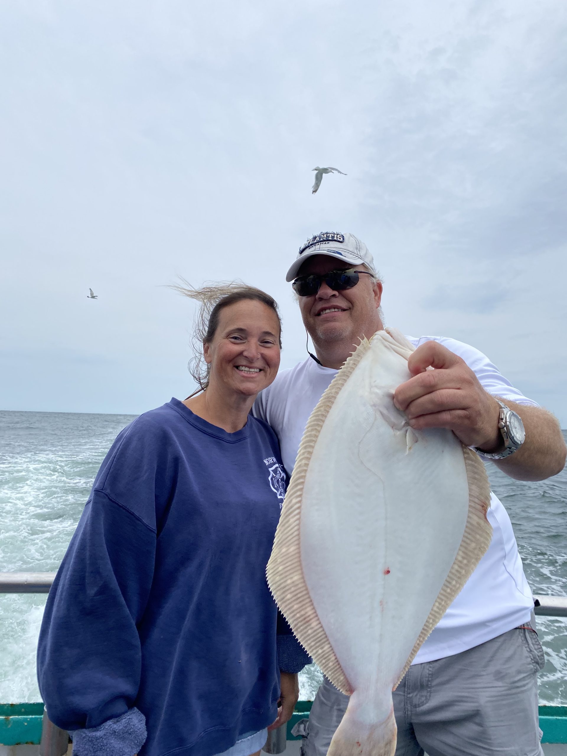 a person holding a fish in the water