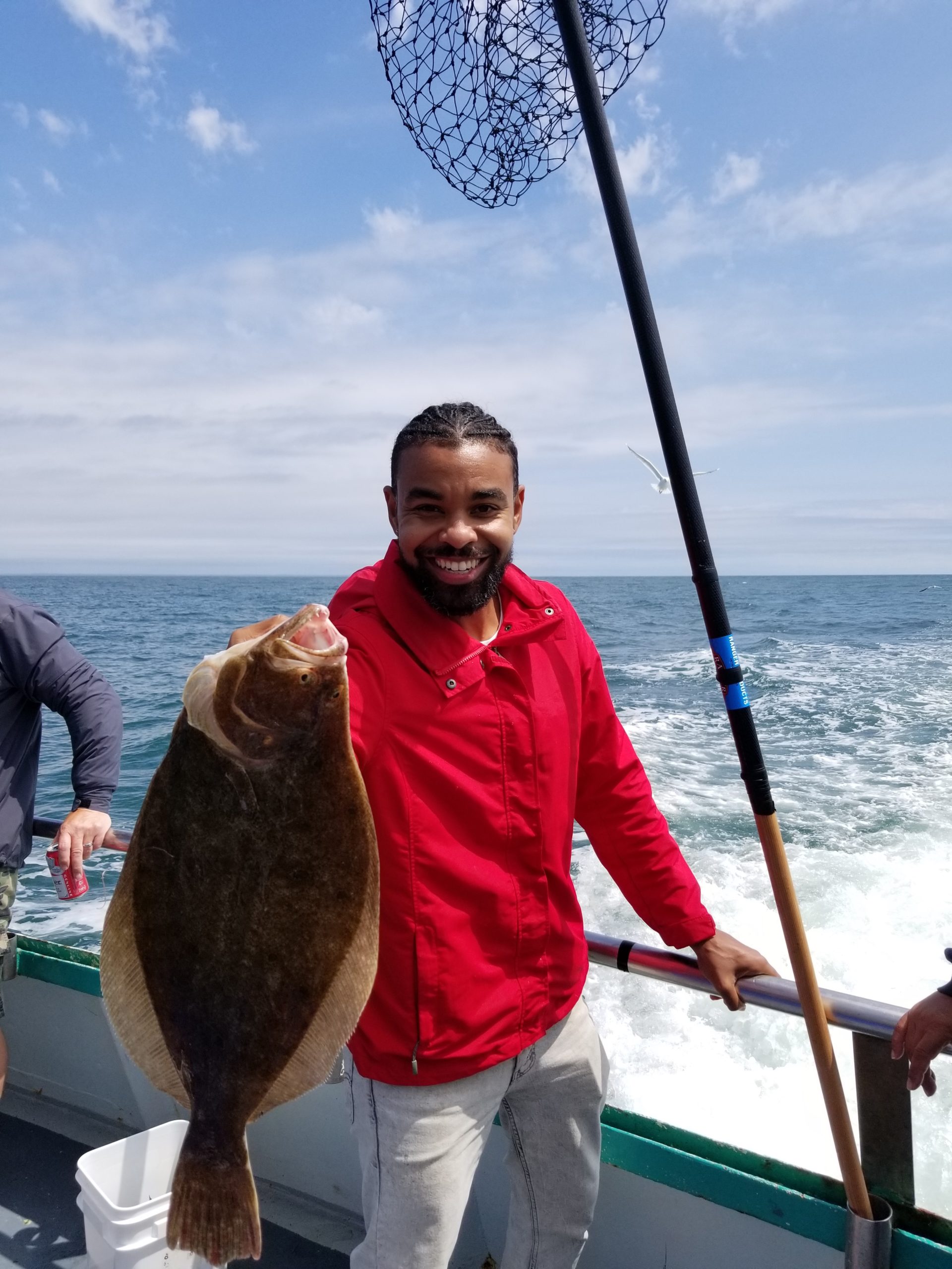 a man holding a fish in the water