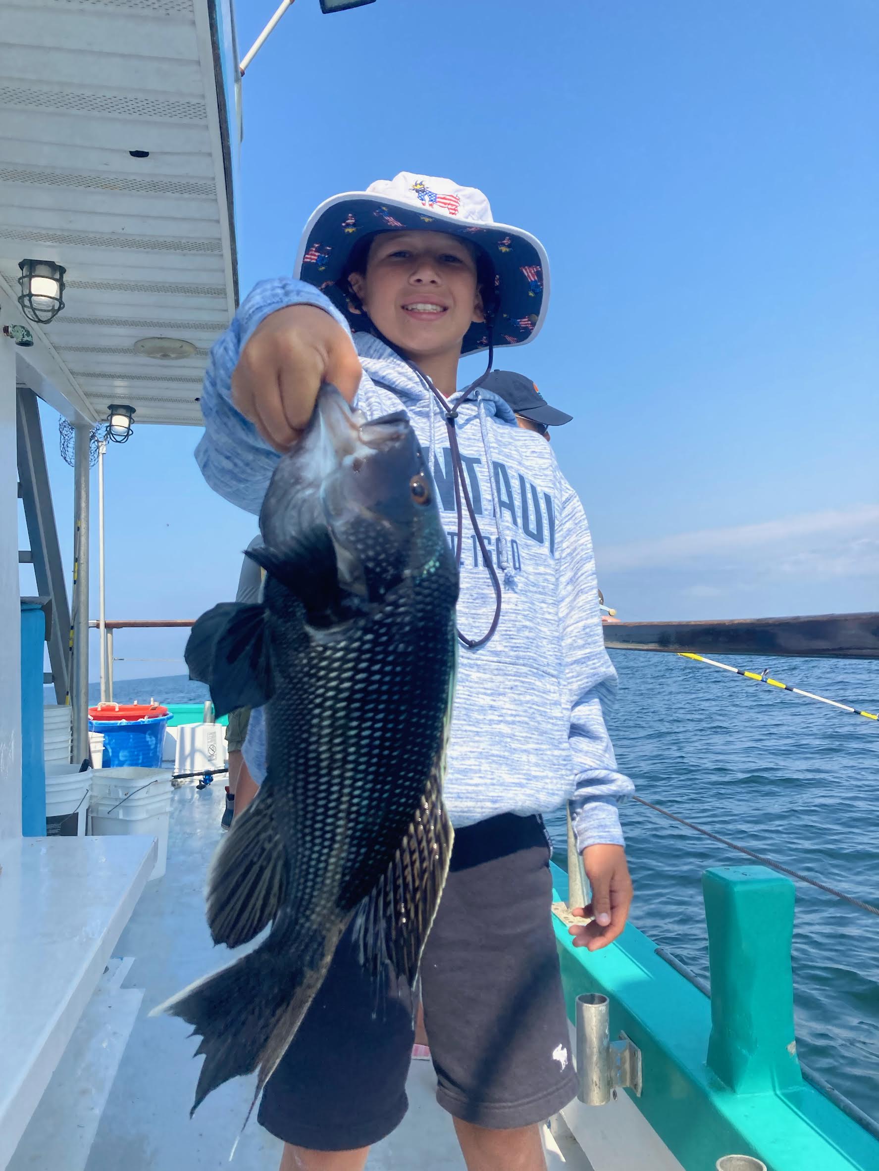 a person holding a fish on a boat