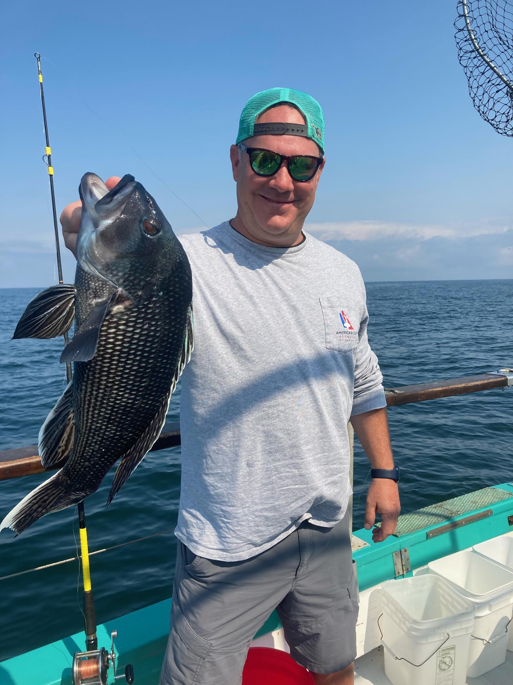 a person holding a fish on a boat