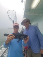 a man holding a fish