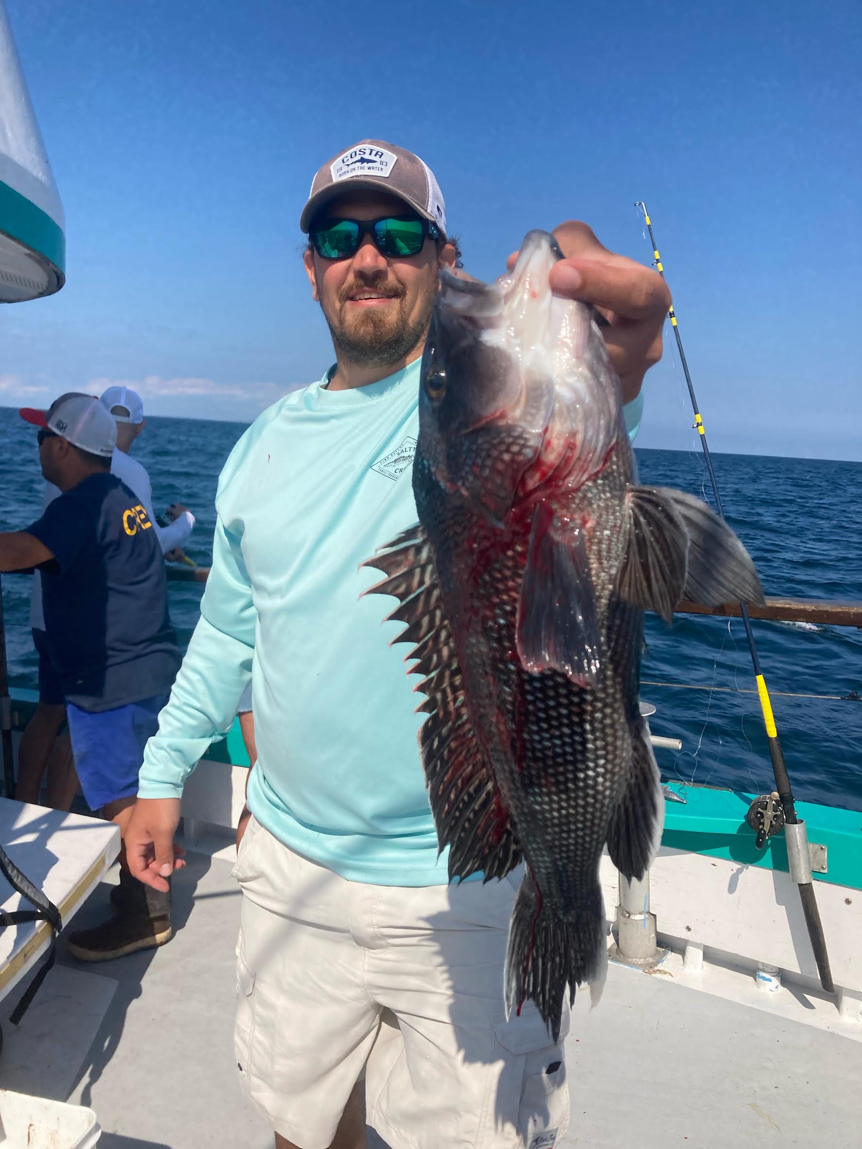 a person holding a fish in the water