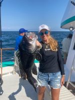 a person holding a fish in the water