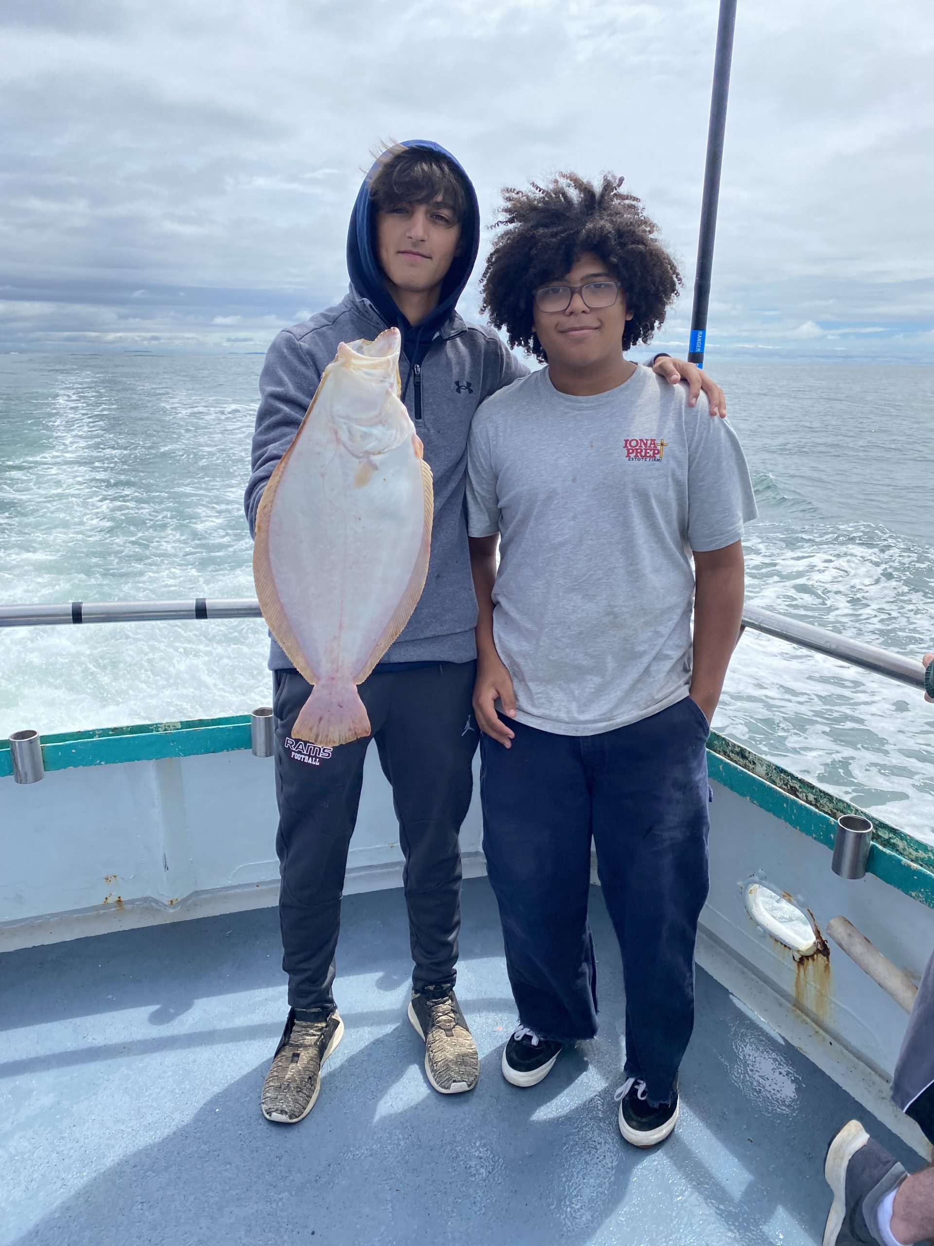 a man and a woman standing next to a body of water