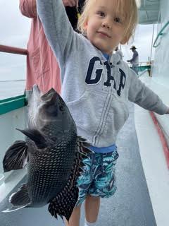 a little girl holding a fish