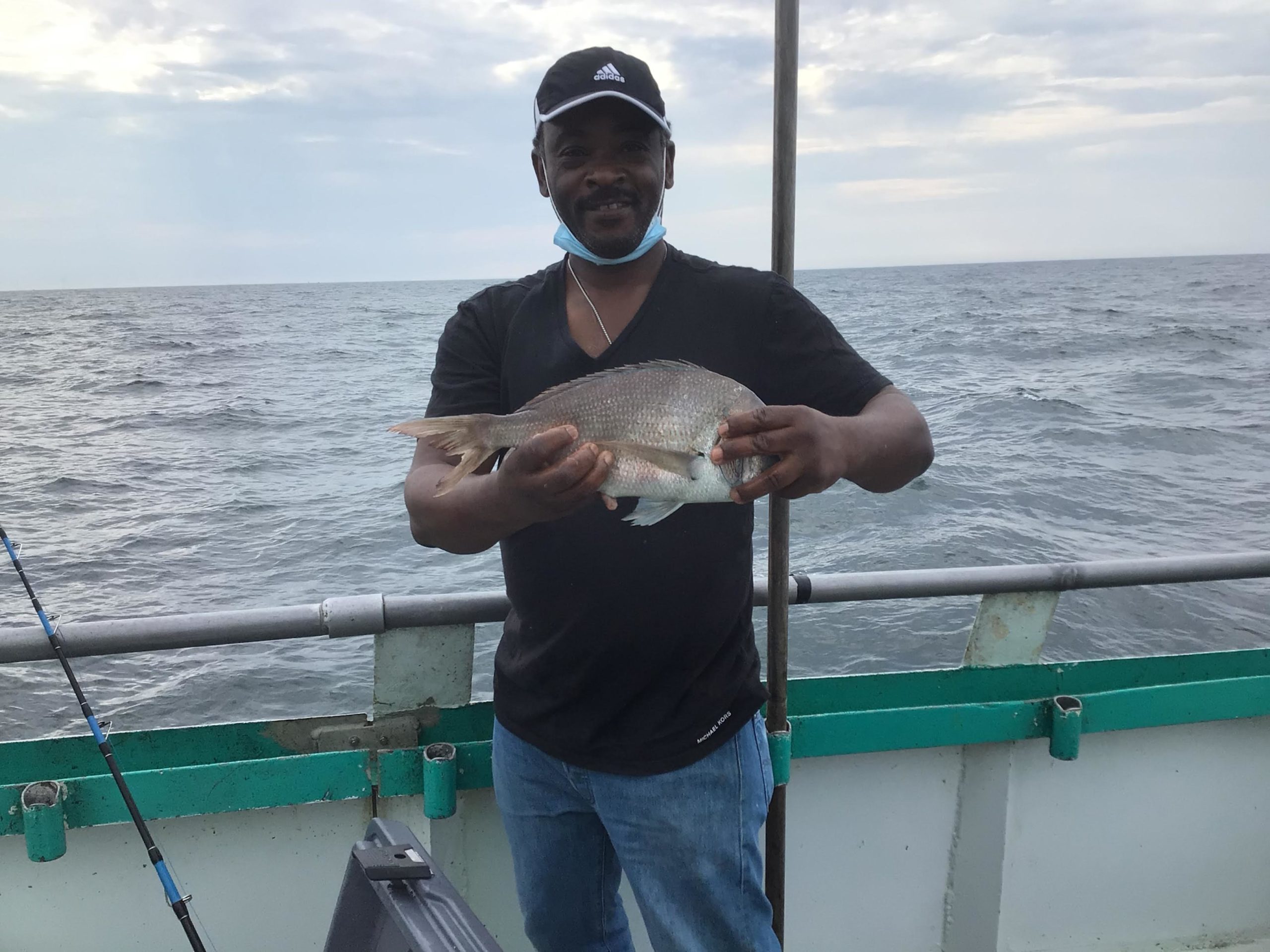 a man holding a fish in the water