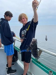 a group of people standing next to a body of water