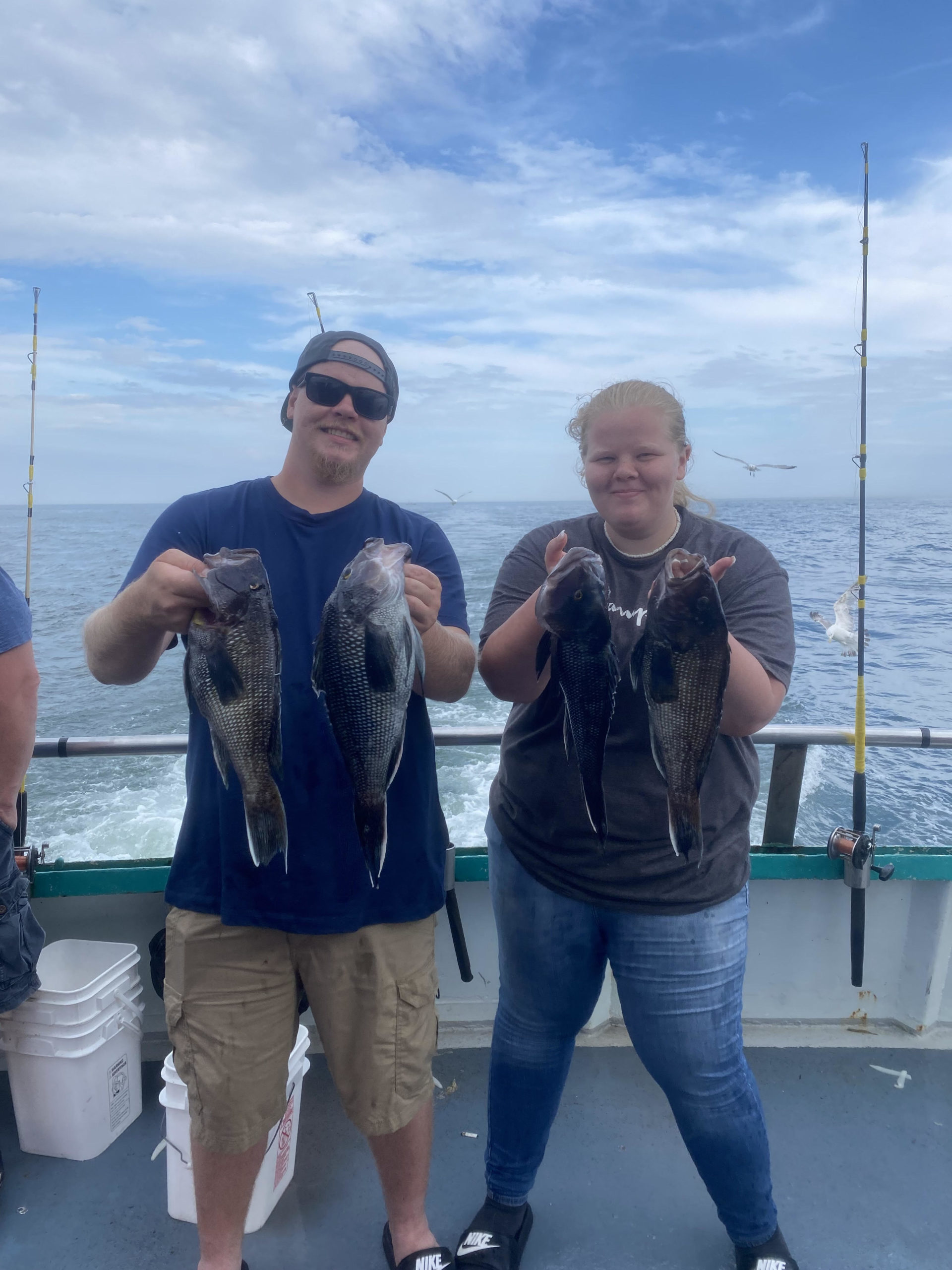 a man and a woman standing next to a body of water