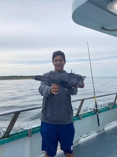 a man standing next to a body of water