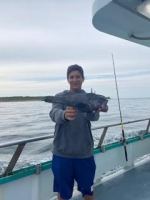 a man standing next to a body of water