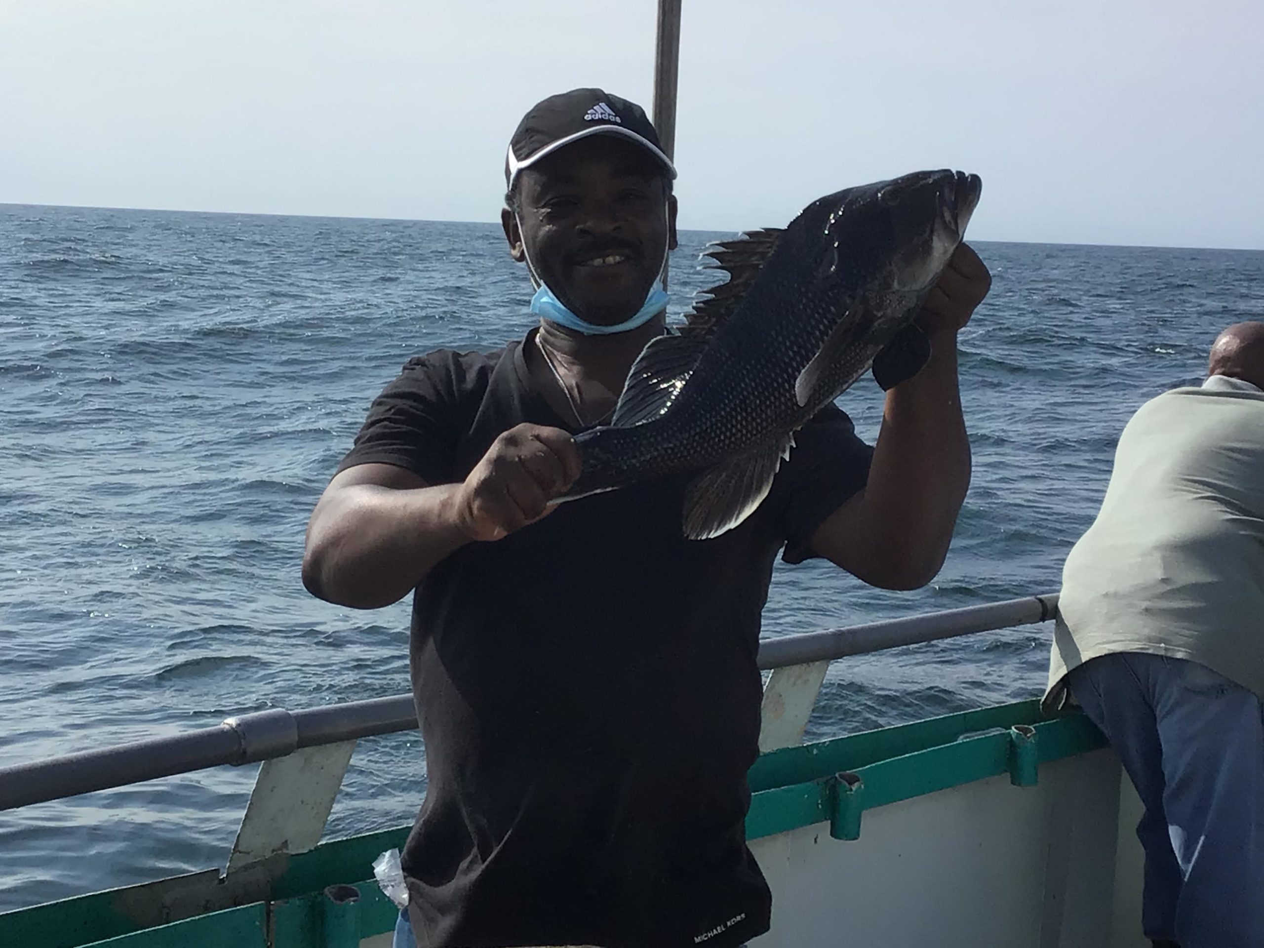 a man holding a fish in the water