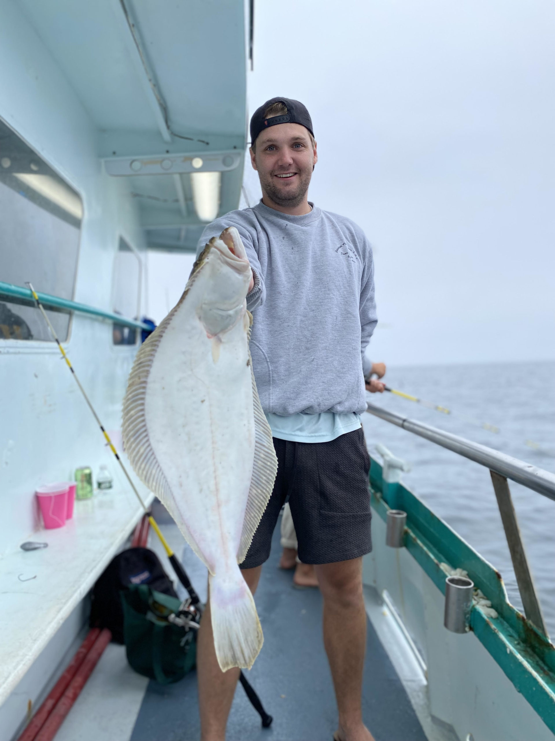 a man holding a fish on a boat