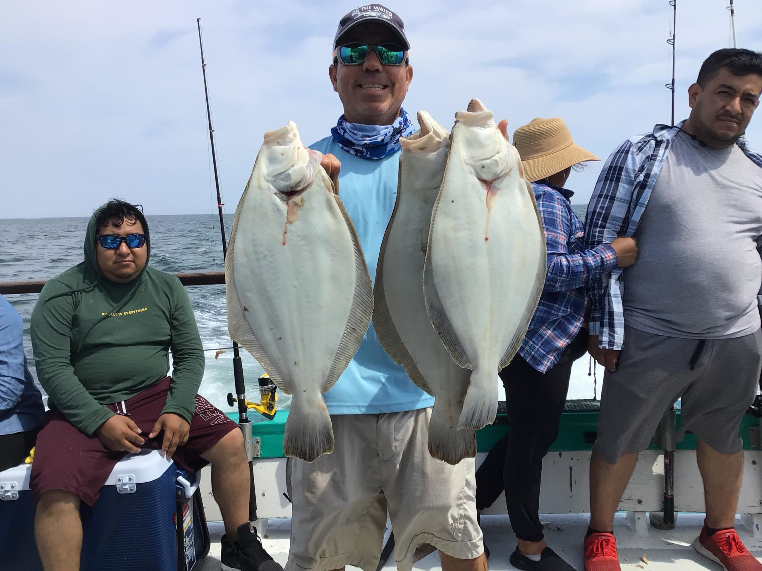 a group of people standing in front of a fish