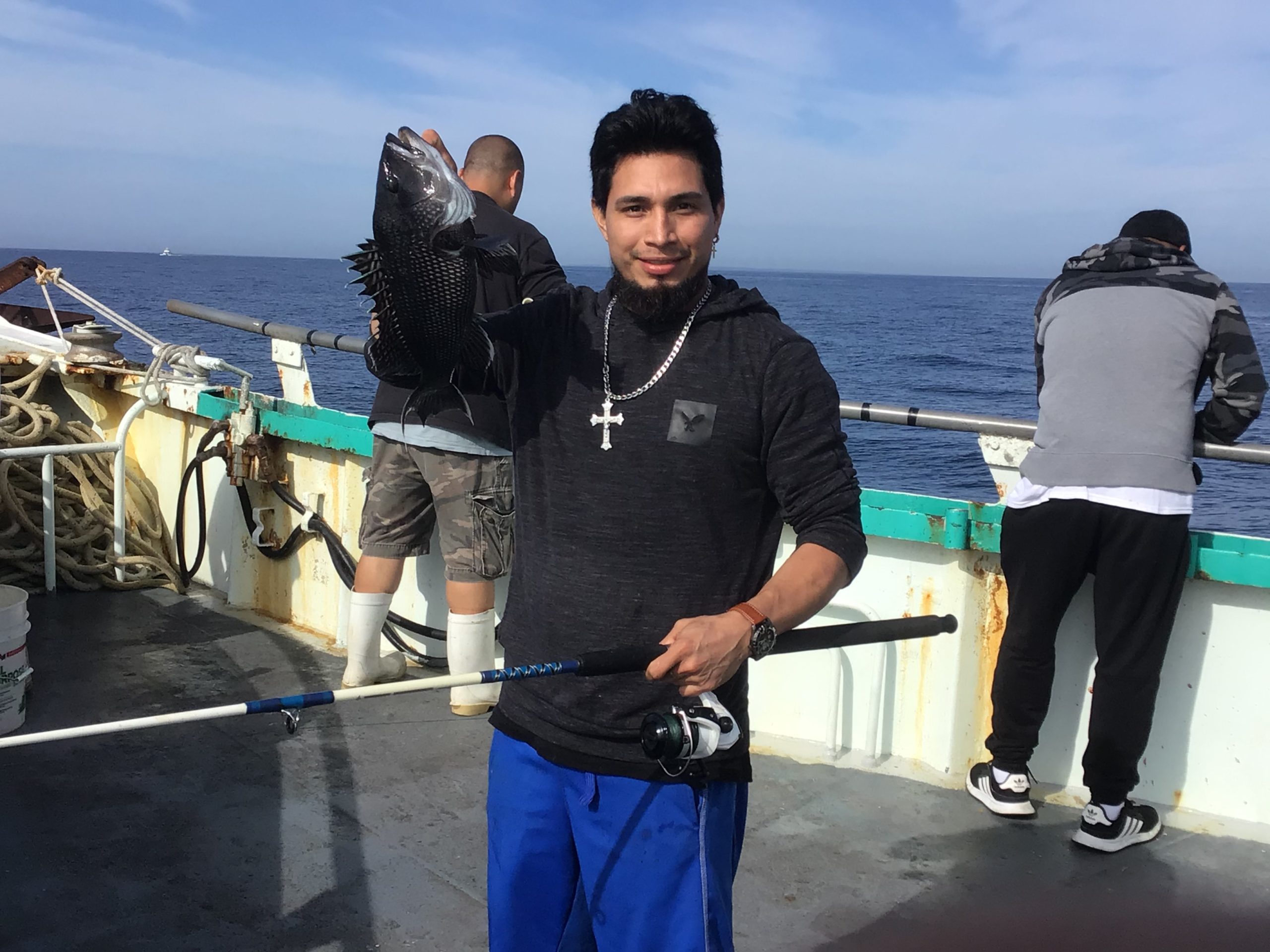 a man standing next to a boat
