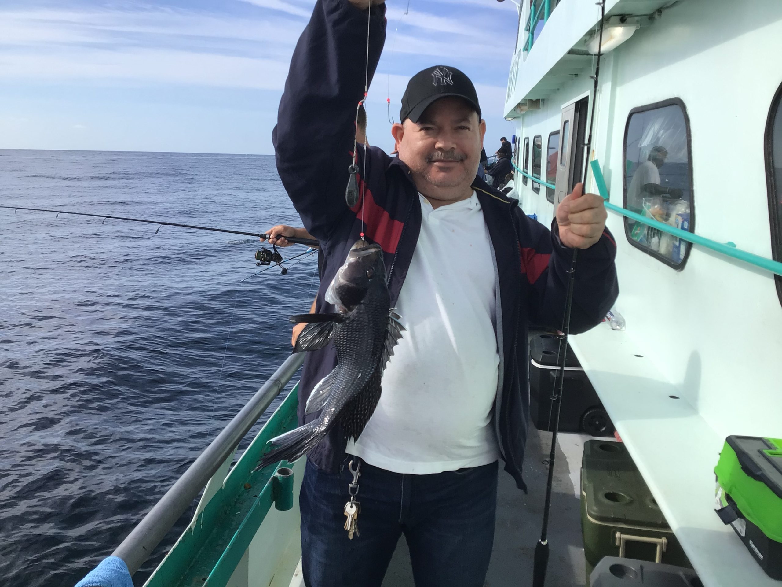 a person holding a fish on a boat in the water