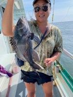 a person holding a fish in the water