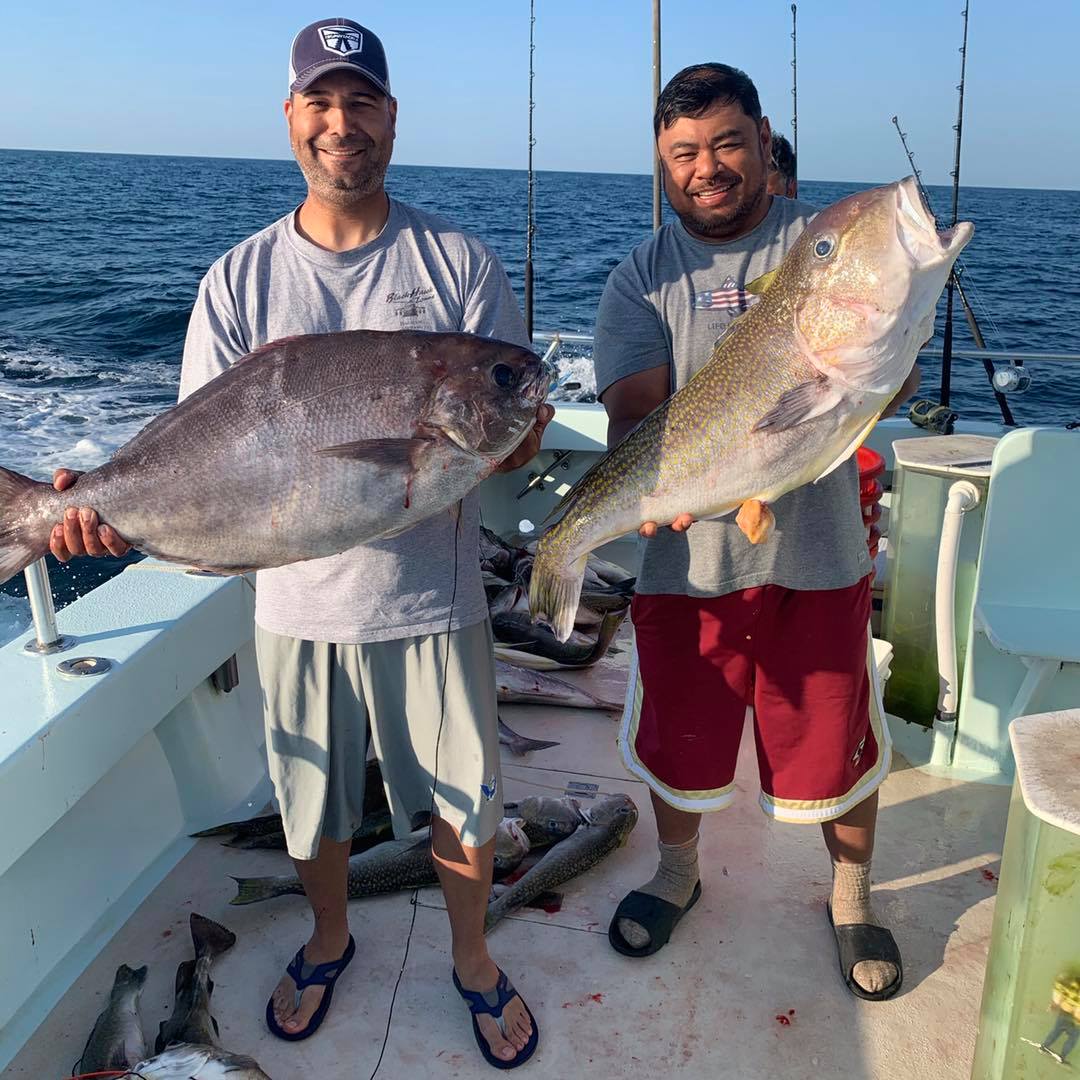 Christopher Alao-Akala holding a fish in the water
