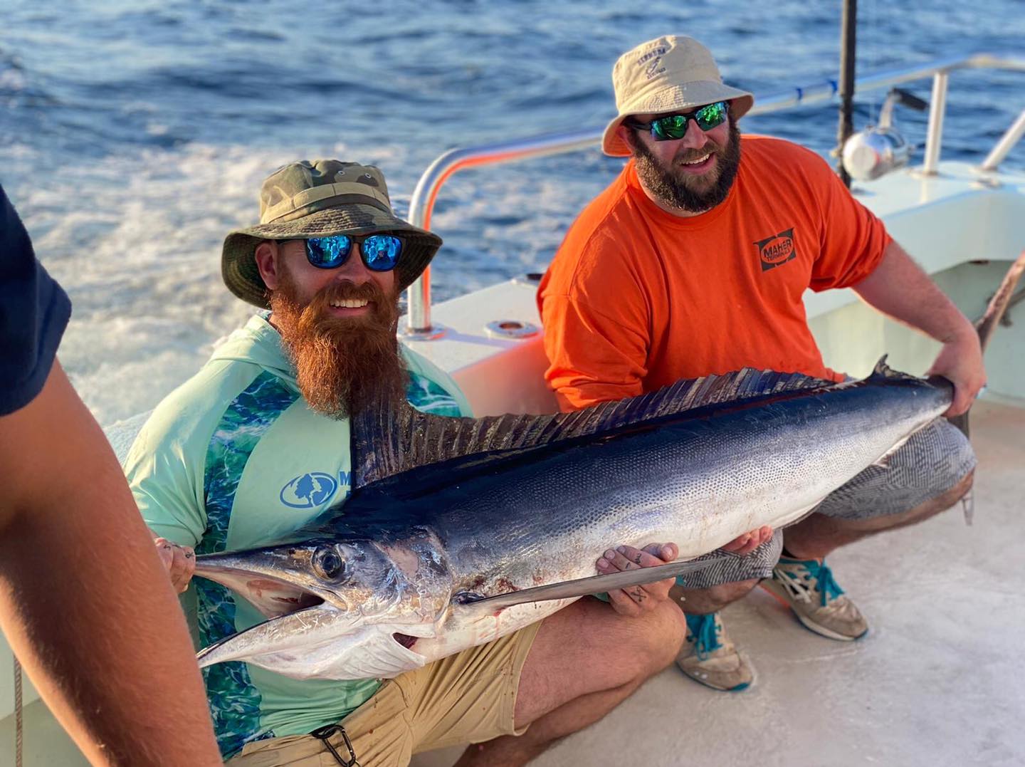 a person holding a fish in the water