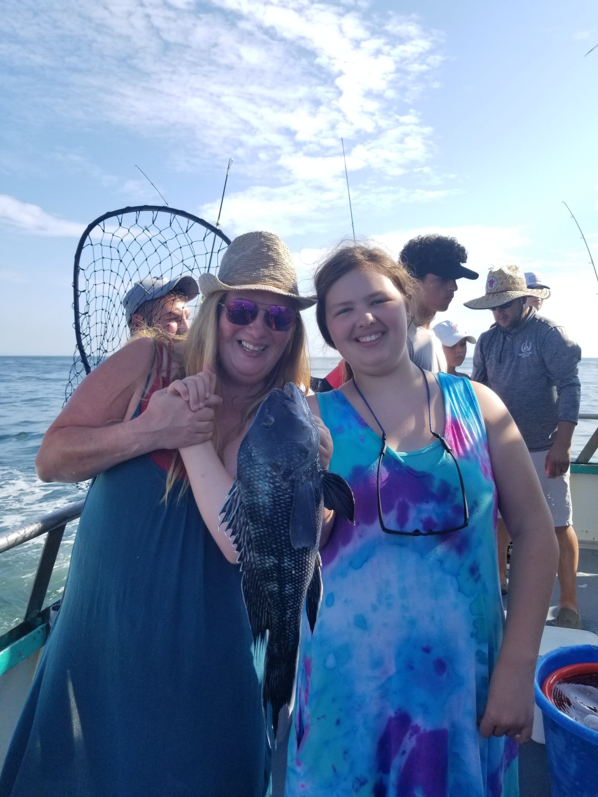 a group of people standing in front of a body of water
