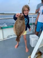 a person holding a fish on a boat in the water