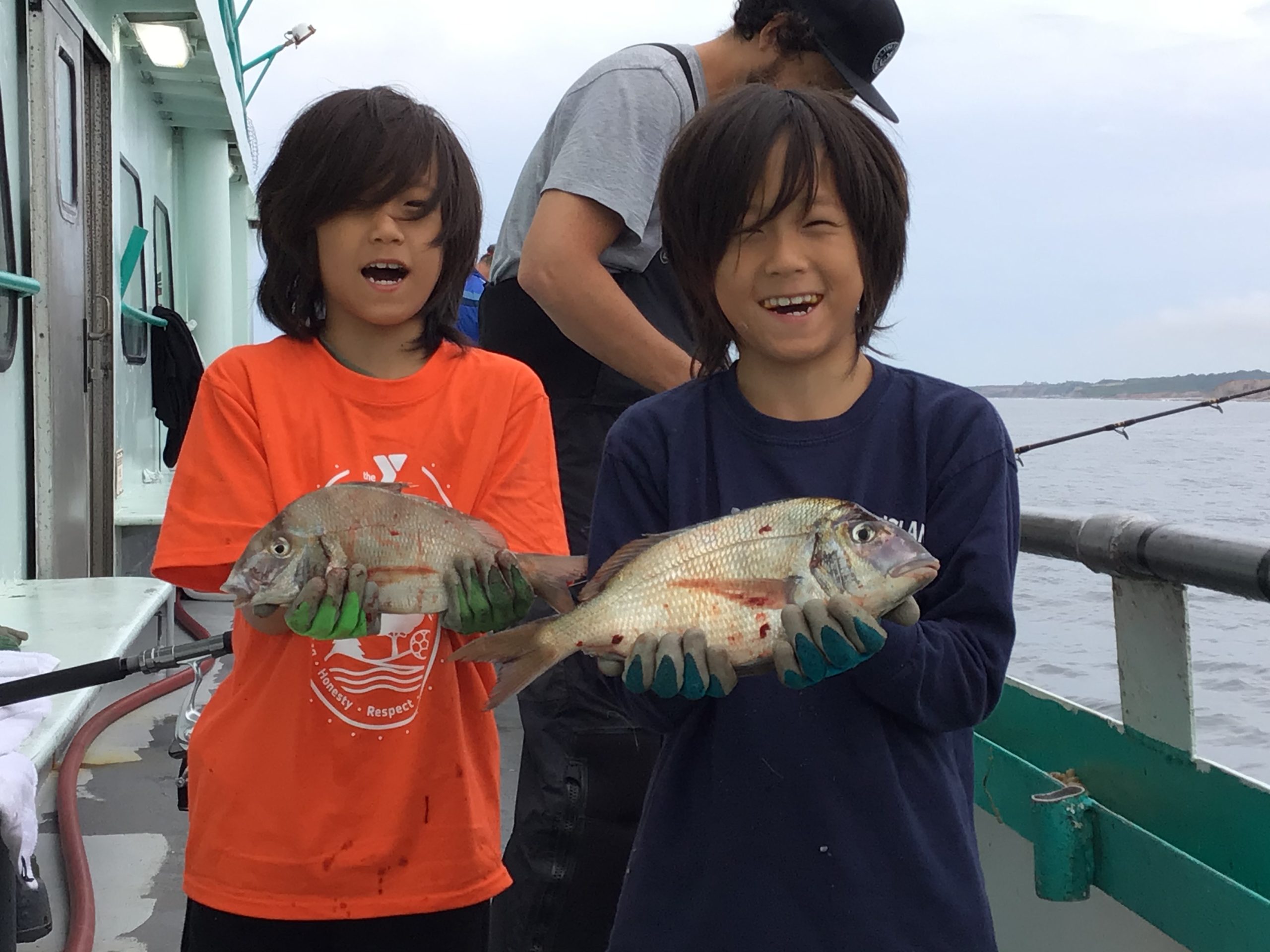 a young boy holding a fish