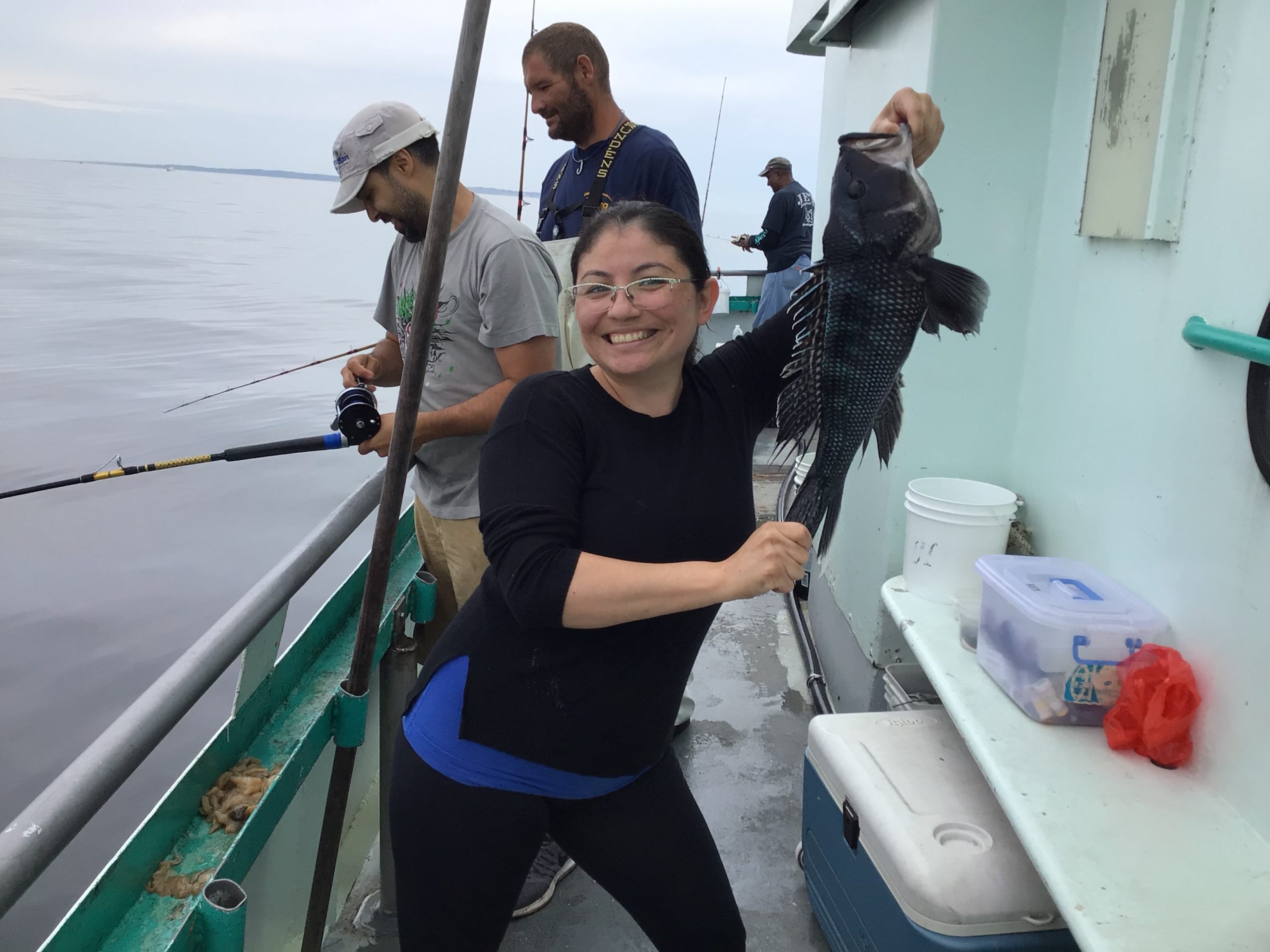 a man and a woman standing on a boat