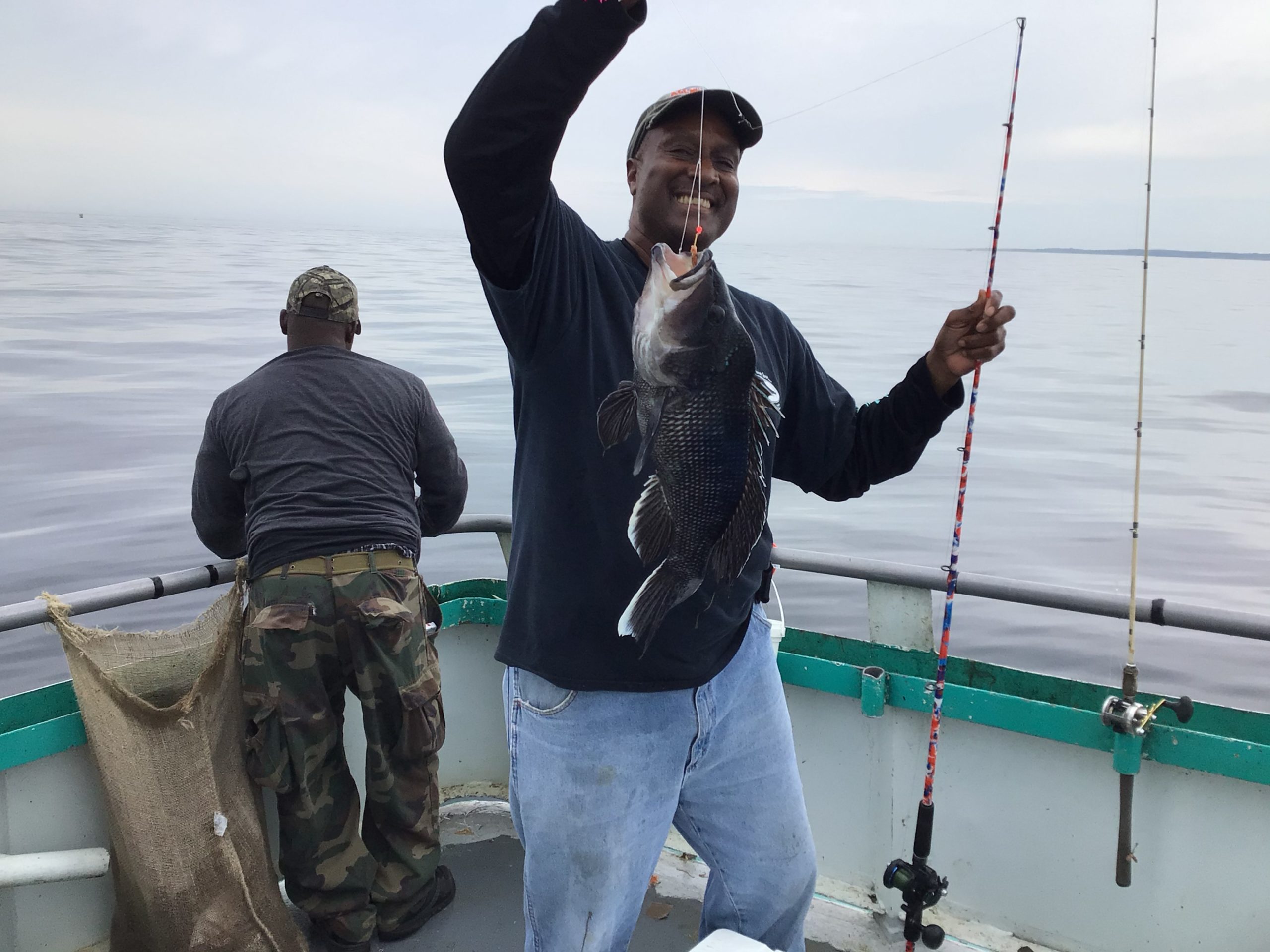 a person holding a kite while standing in the water