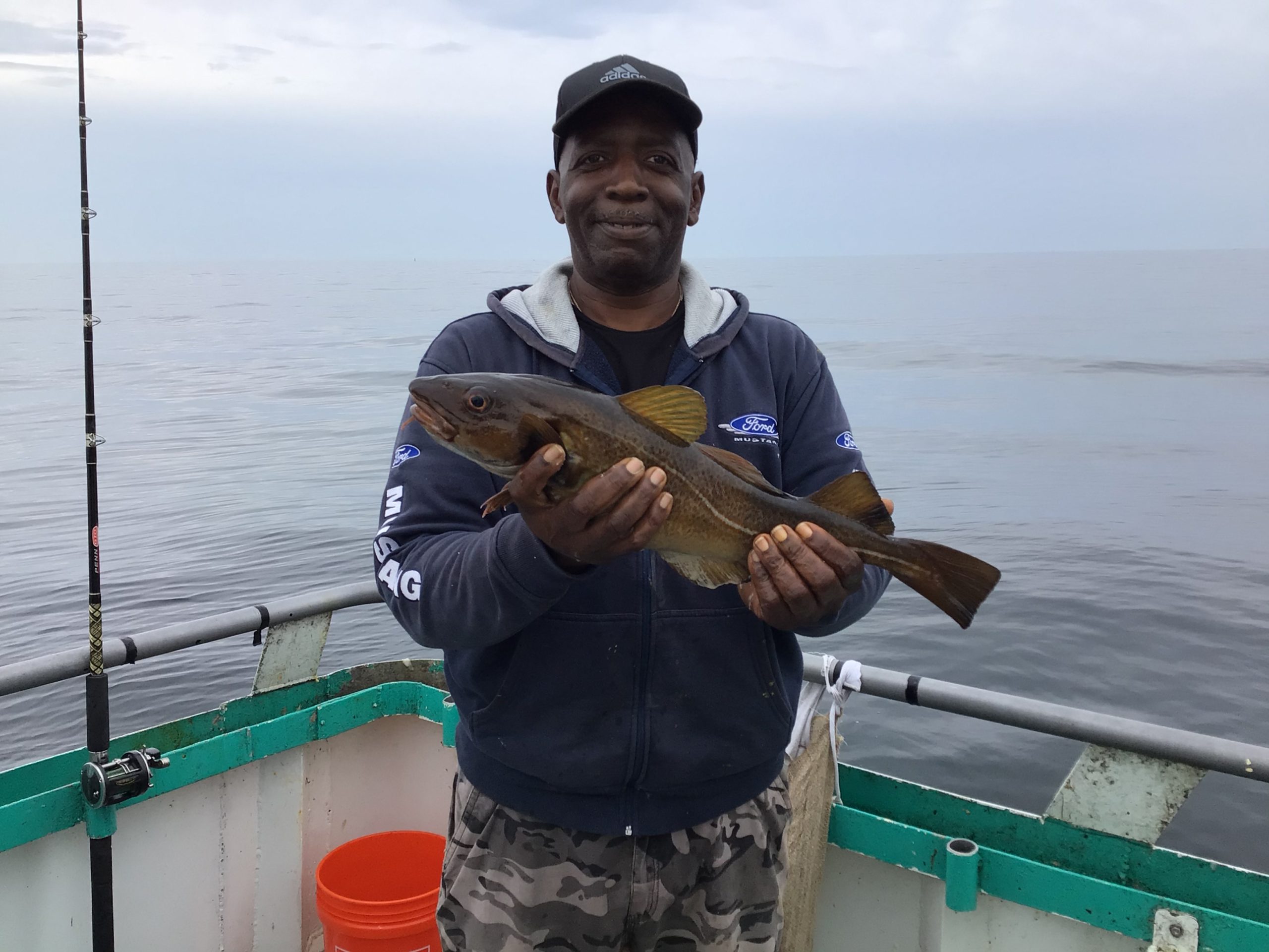 Robert C. Henry holding a fish in the water