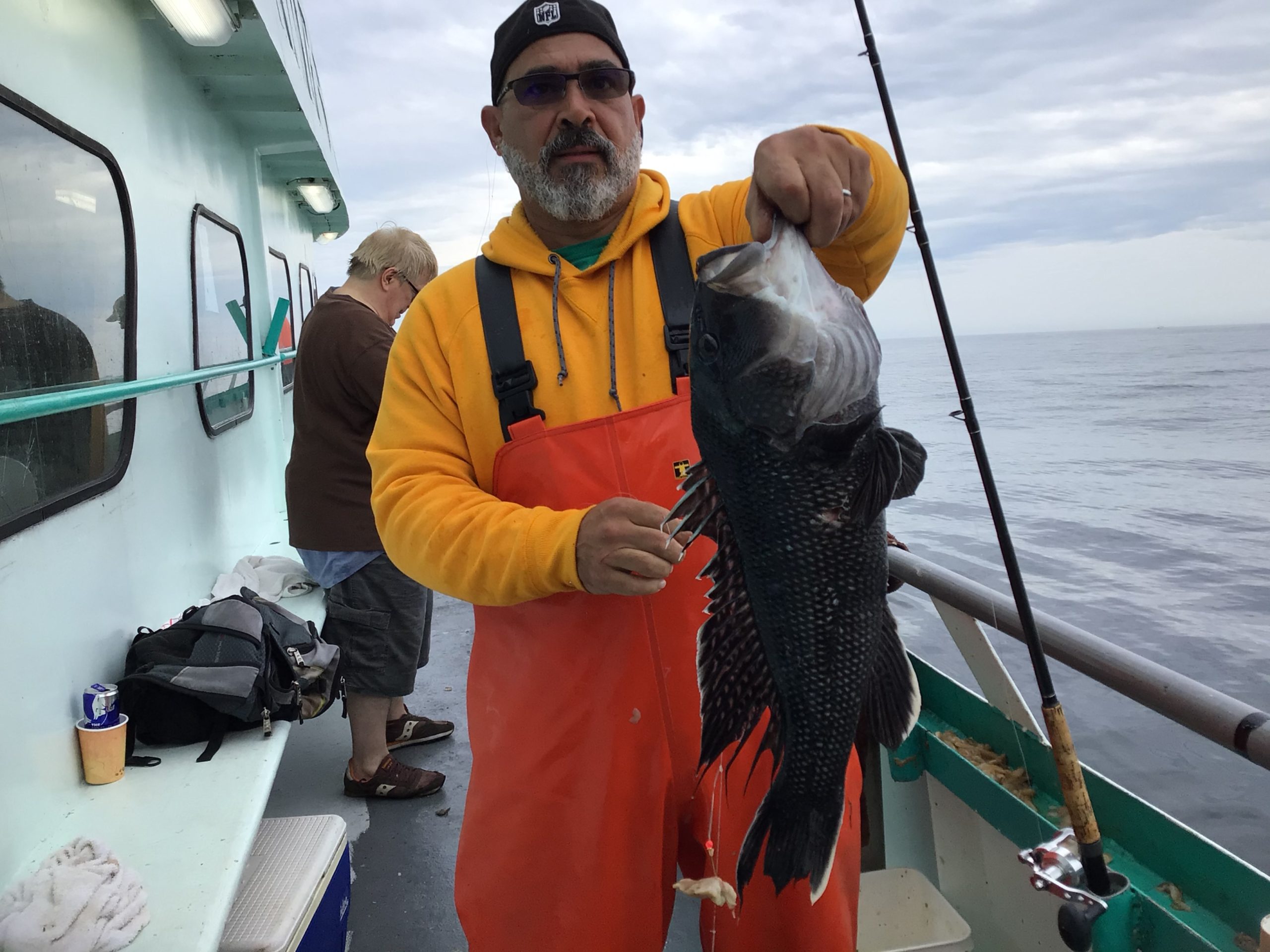 a man holding a fish in the water