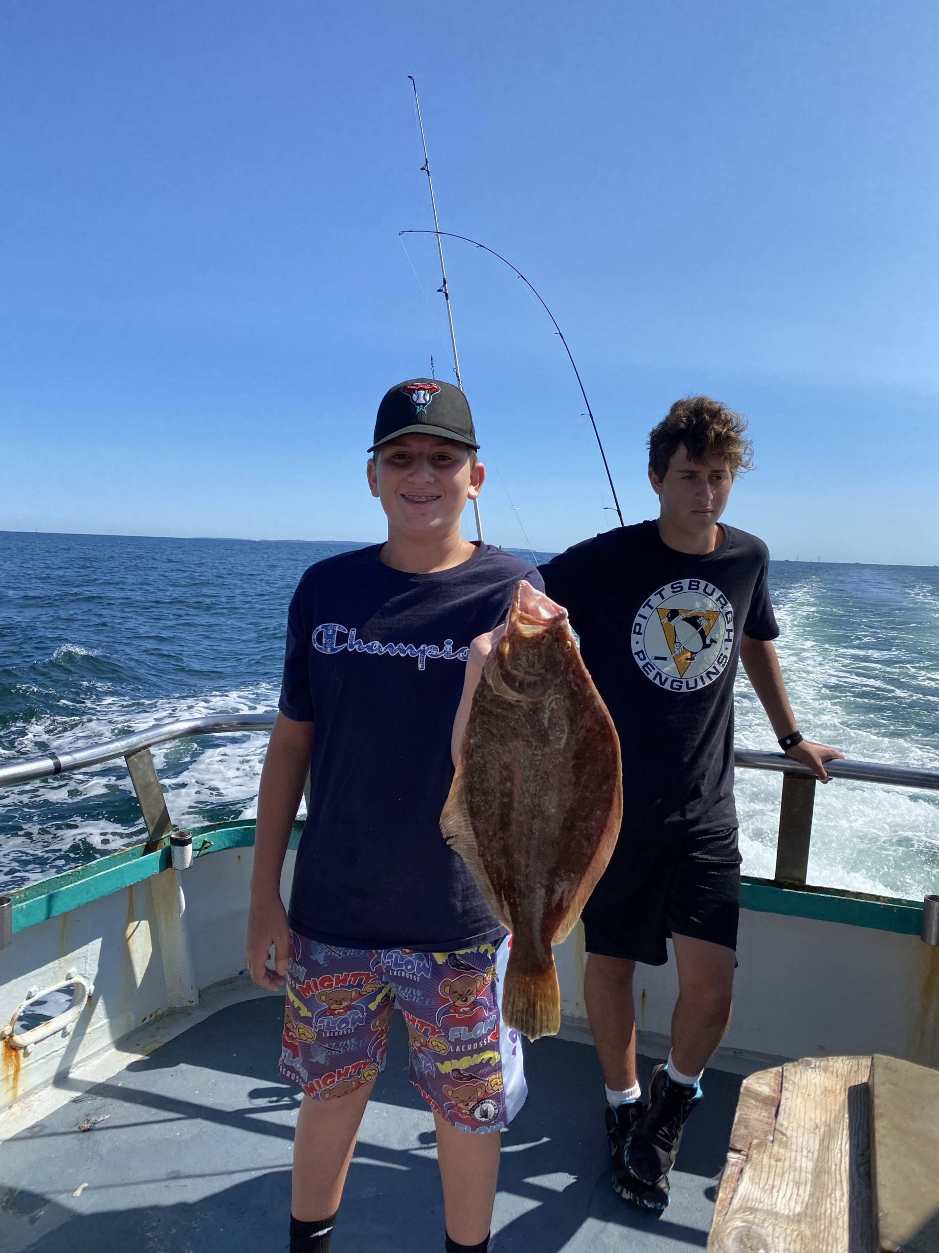 a couple of people that are standing in front of a body of water