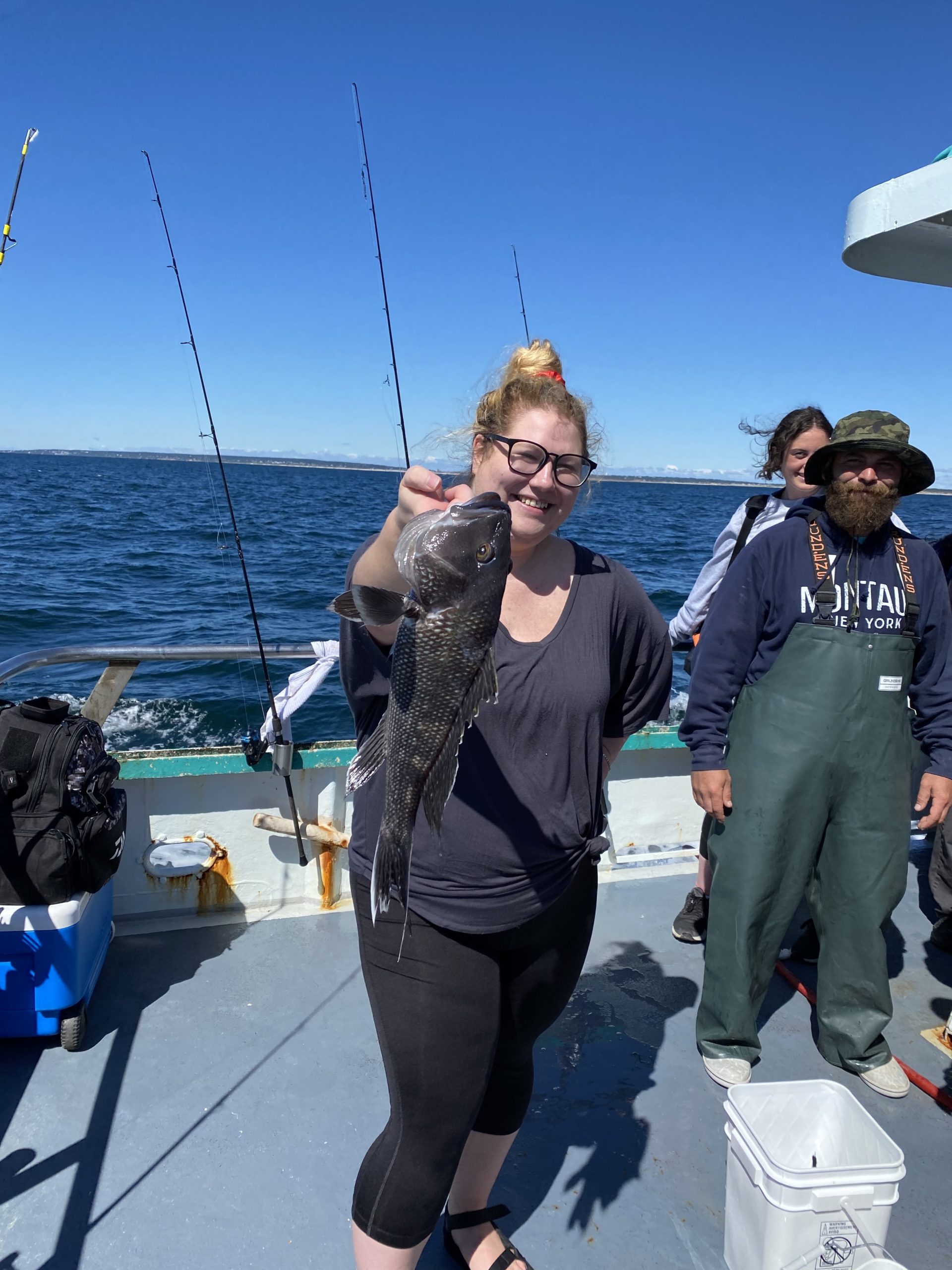 a group of people standing next to a body of water