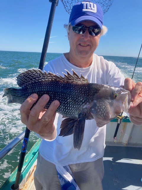 a man holding a fish in the water