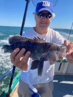 a man holding a fish in the water