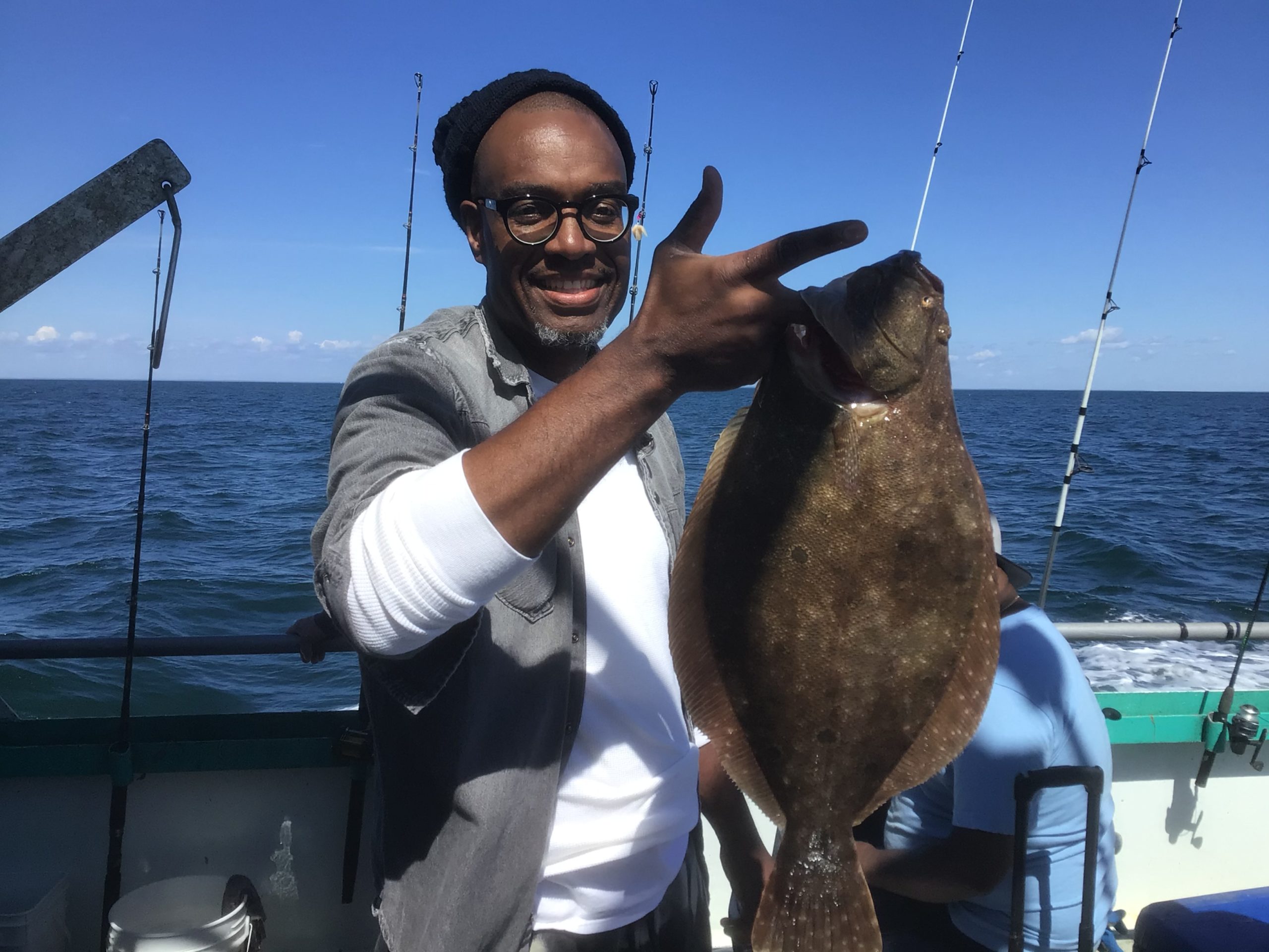 a man holding a fish in the water