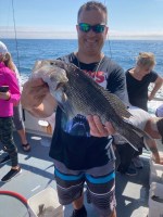 a person holding a fish in the water