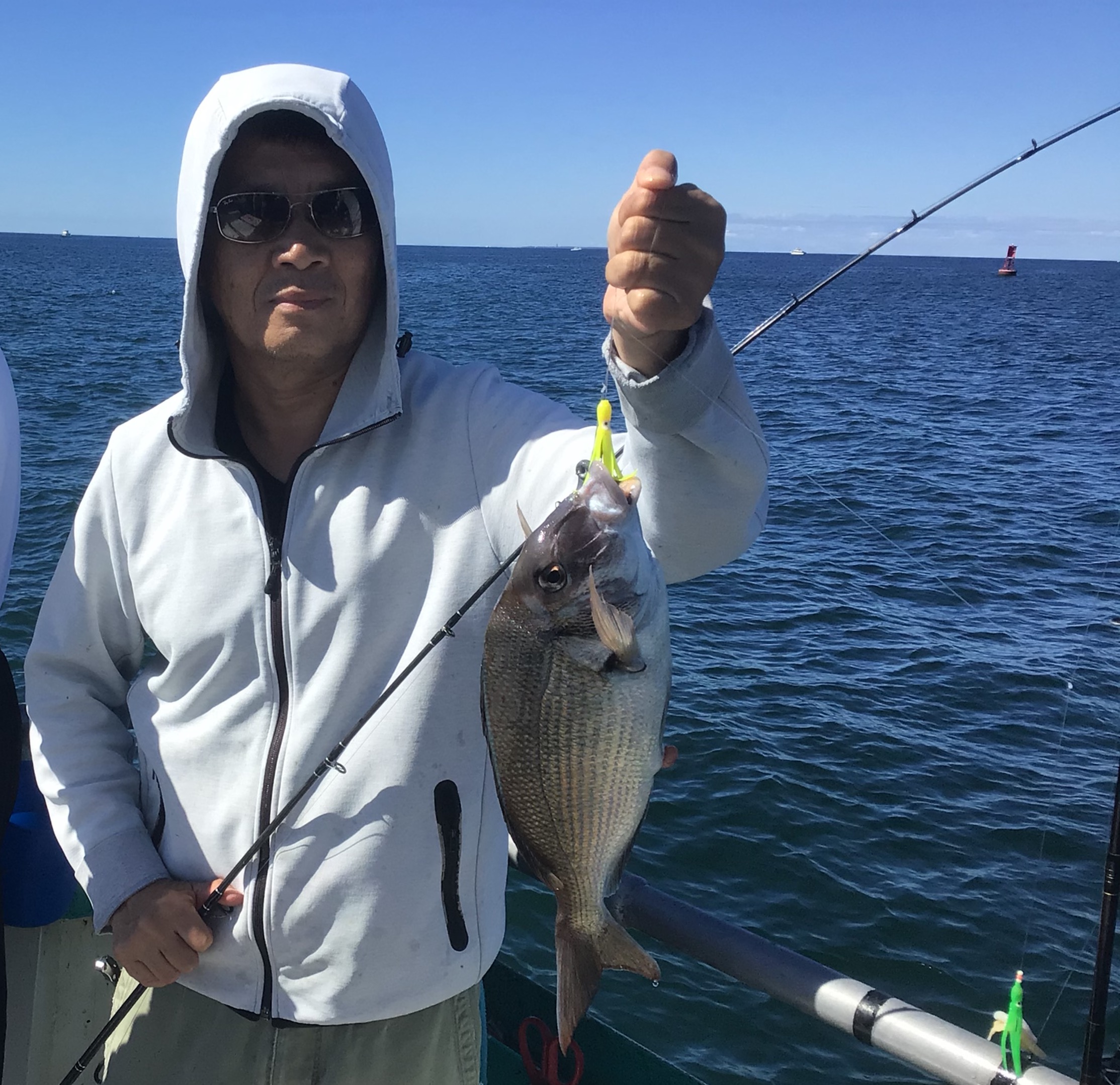 a man holding a fish in the water
