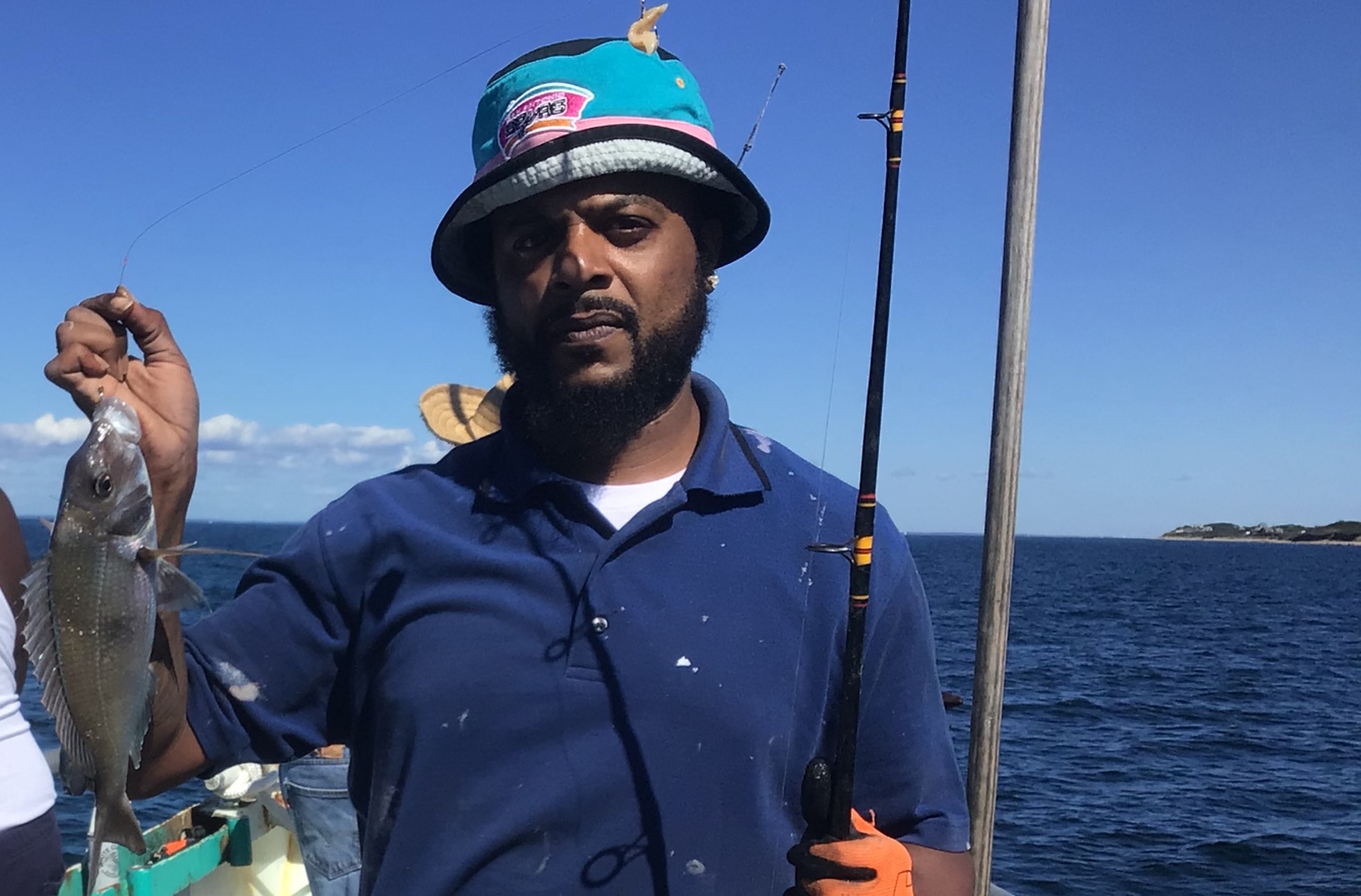 a man holding a fish in the water