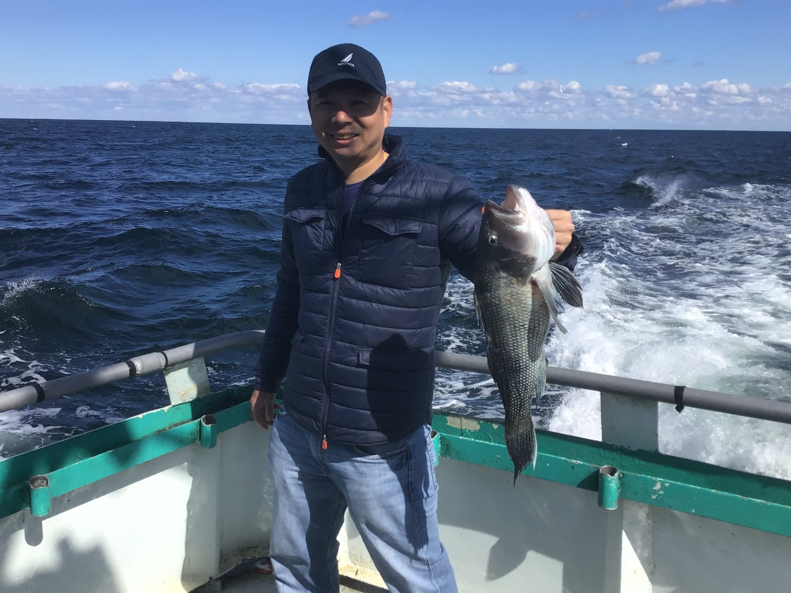 a man holding a fish in the water