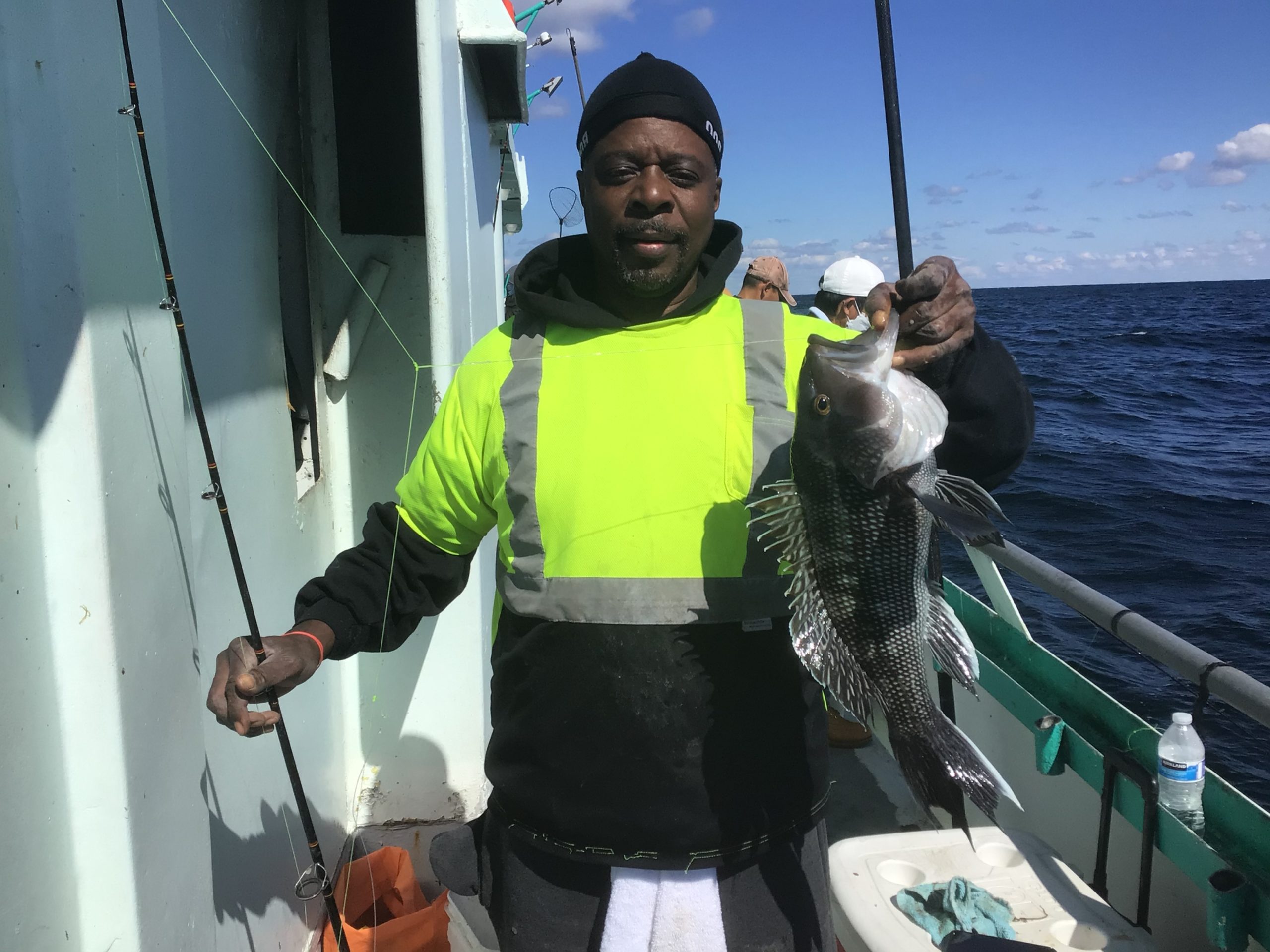 a person holding a fish on a boat