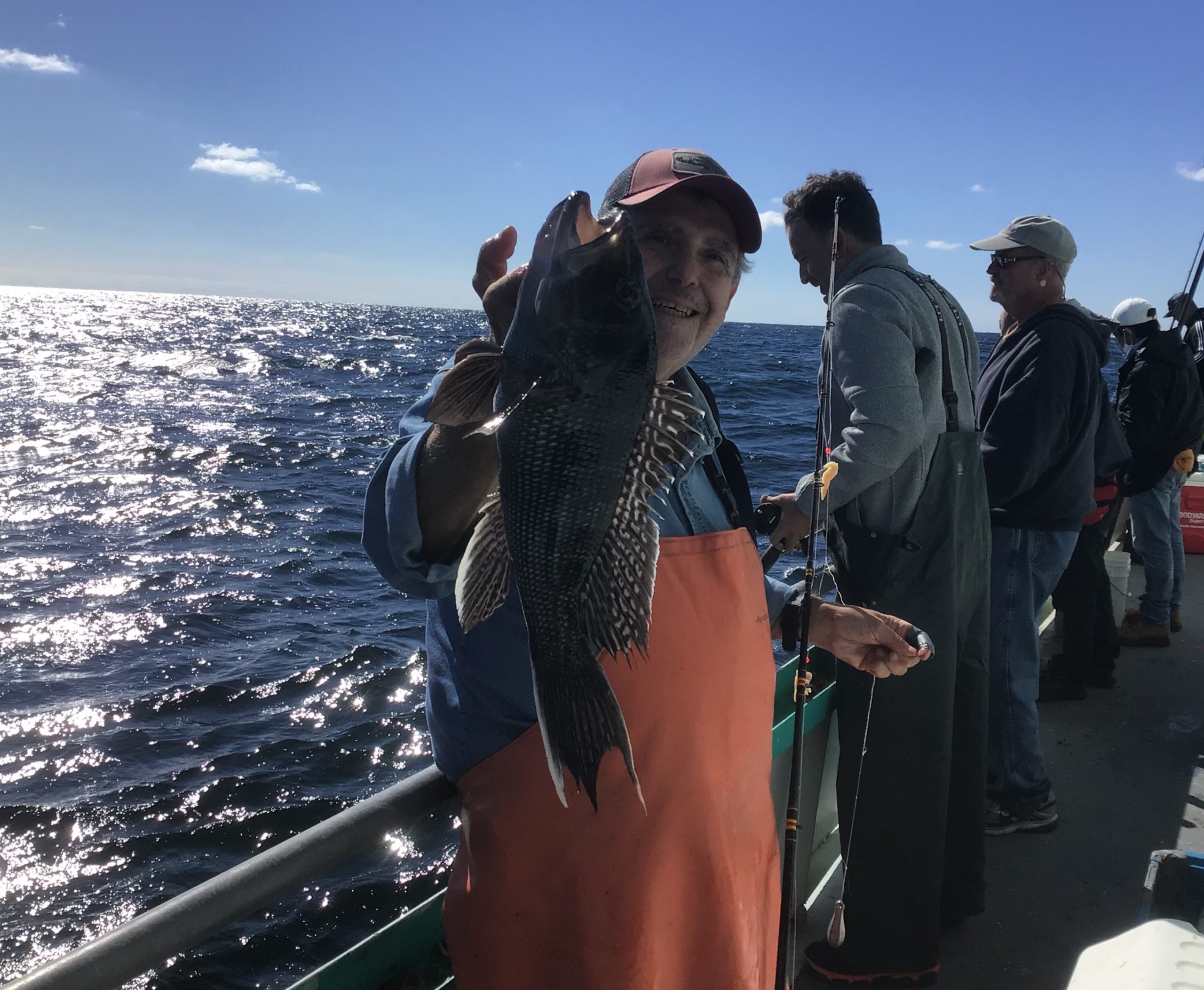 a group of people standing next to a body of water