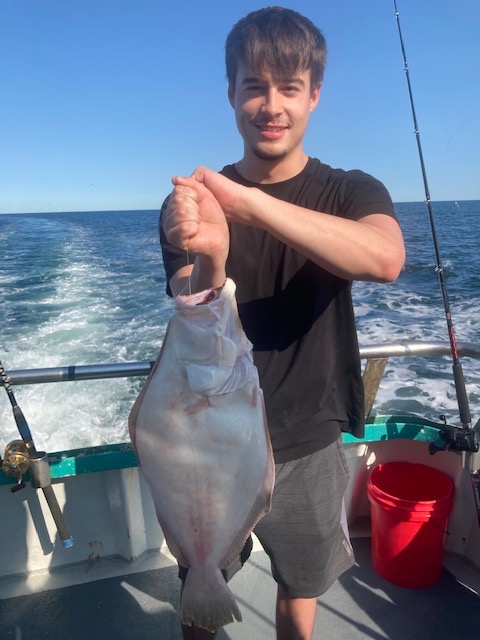 a man holding a fish in the water