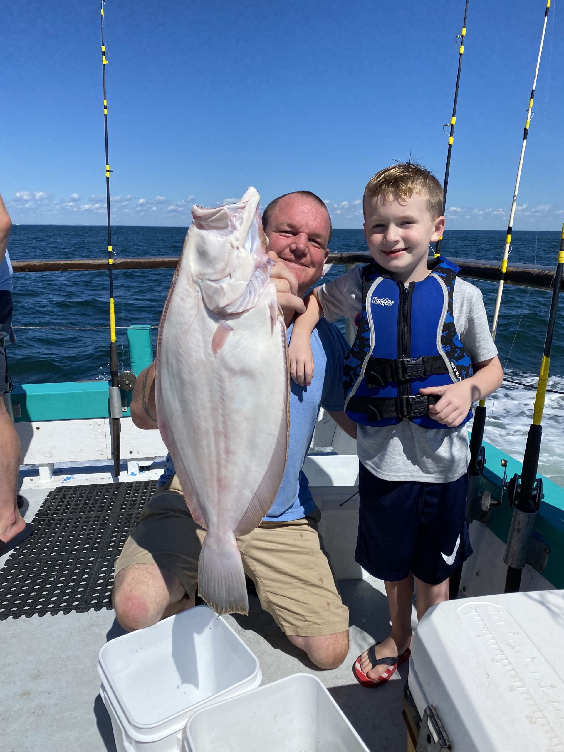 a young boy holding a fish