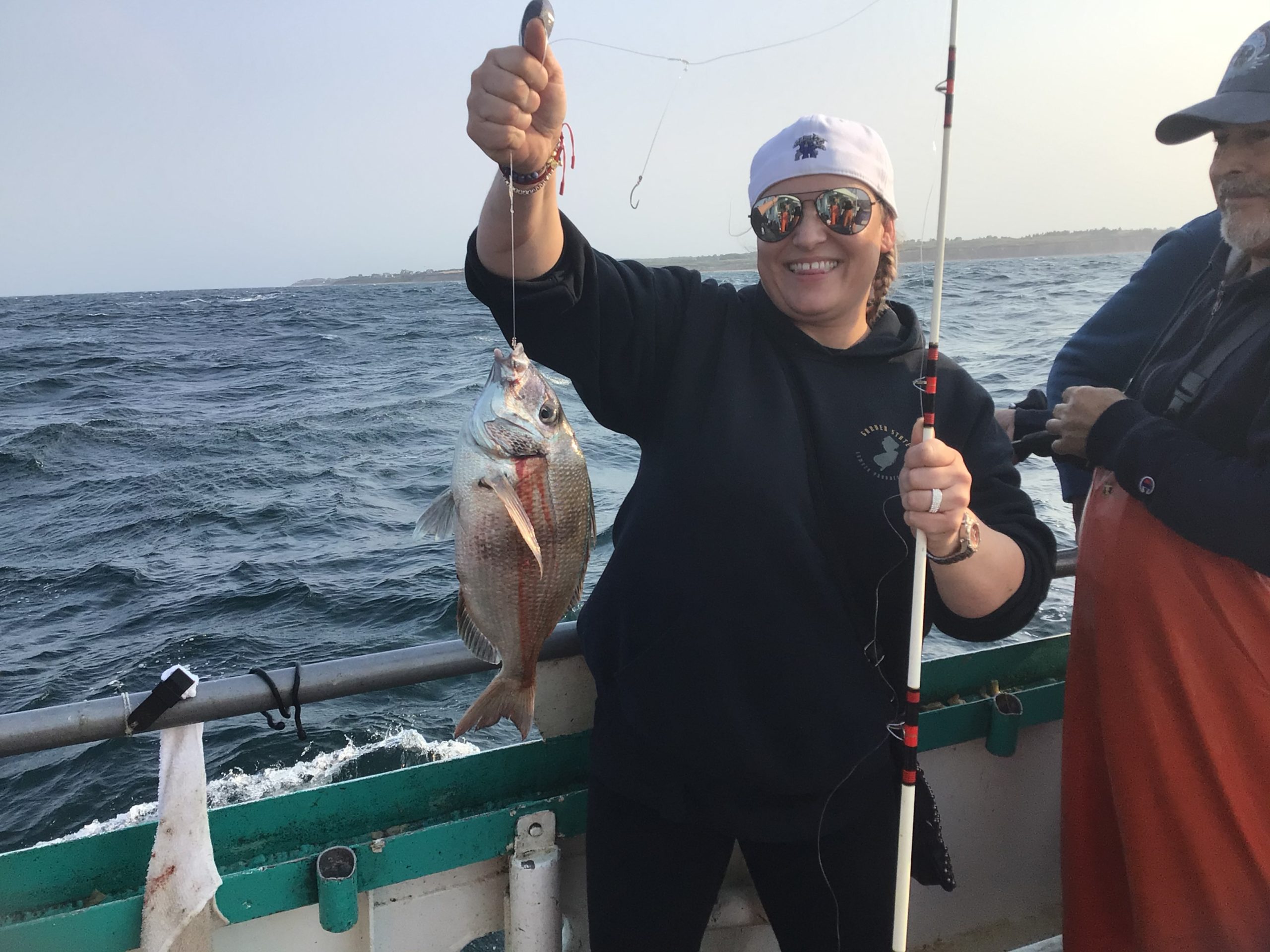 a person holding a fish in the water