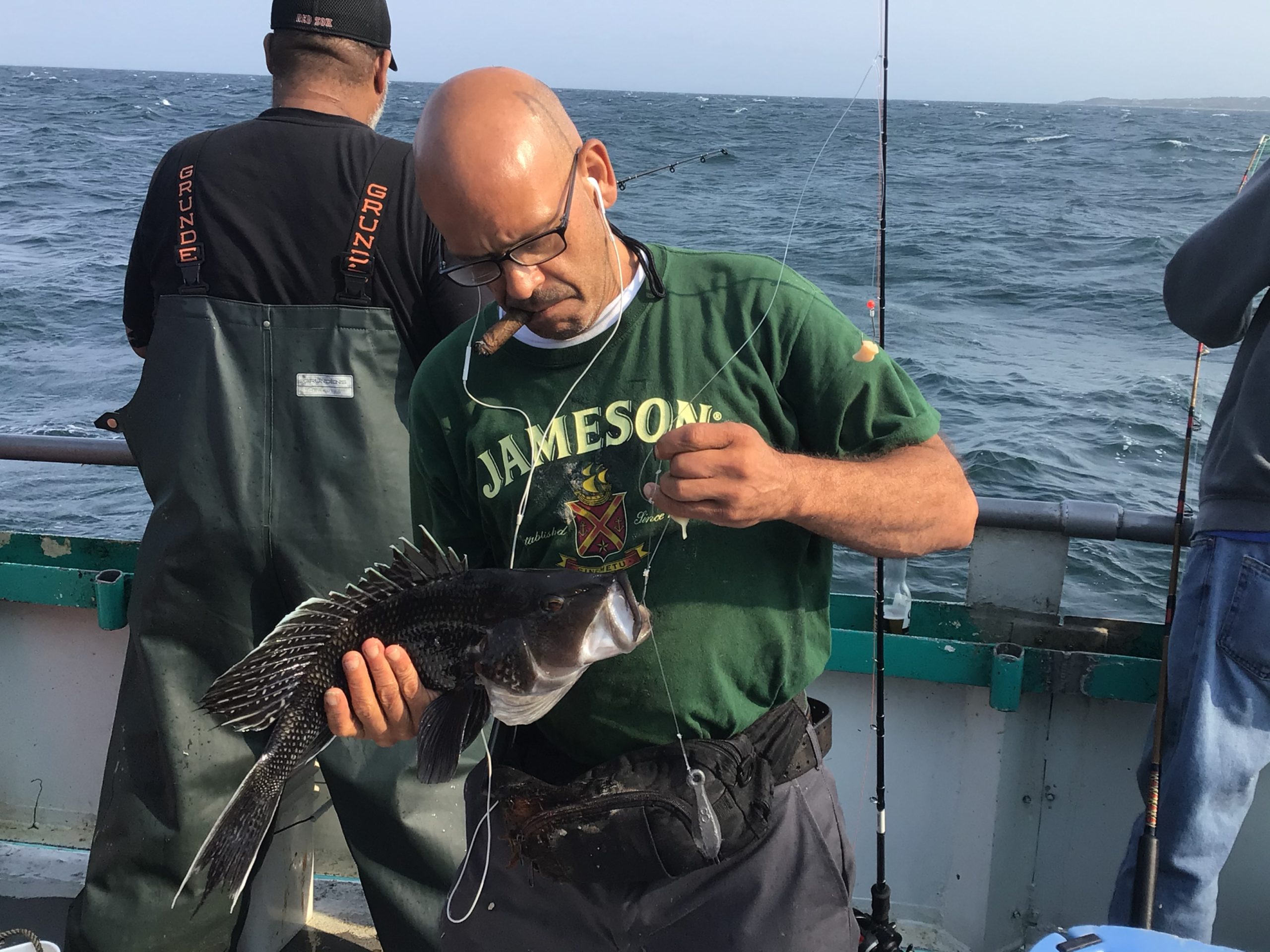a man holding a fish in the water