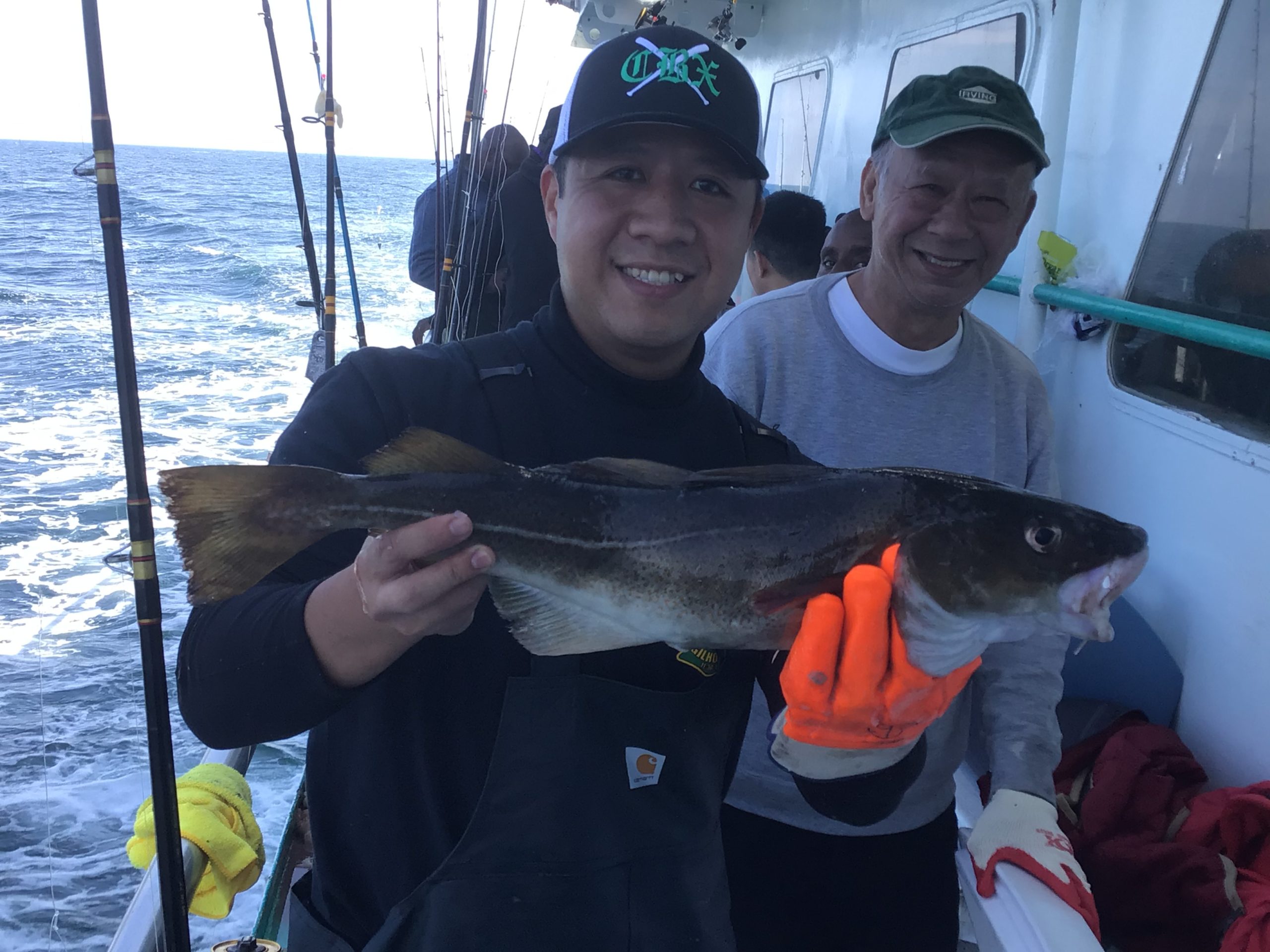 a person holding a fish on a boat
