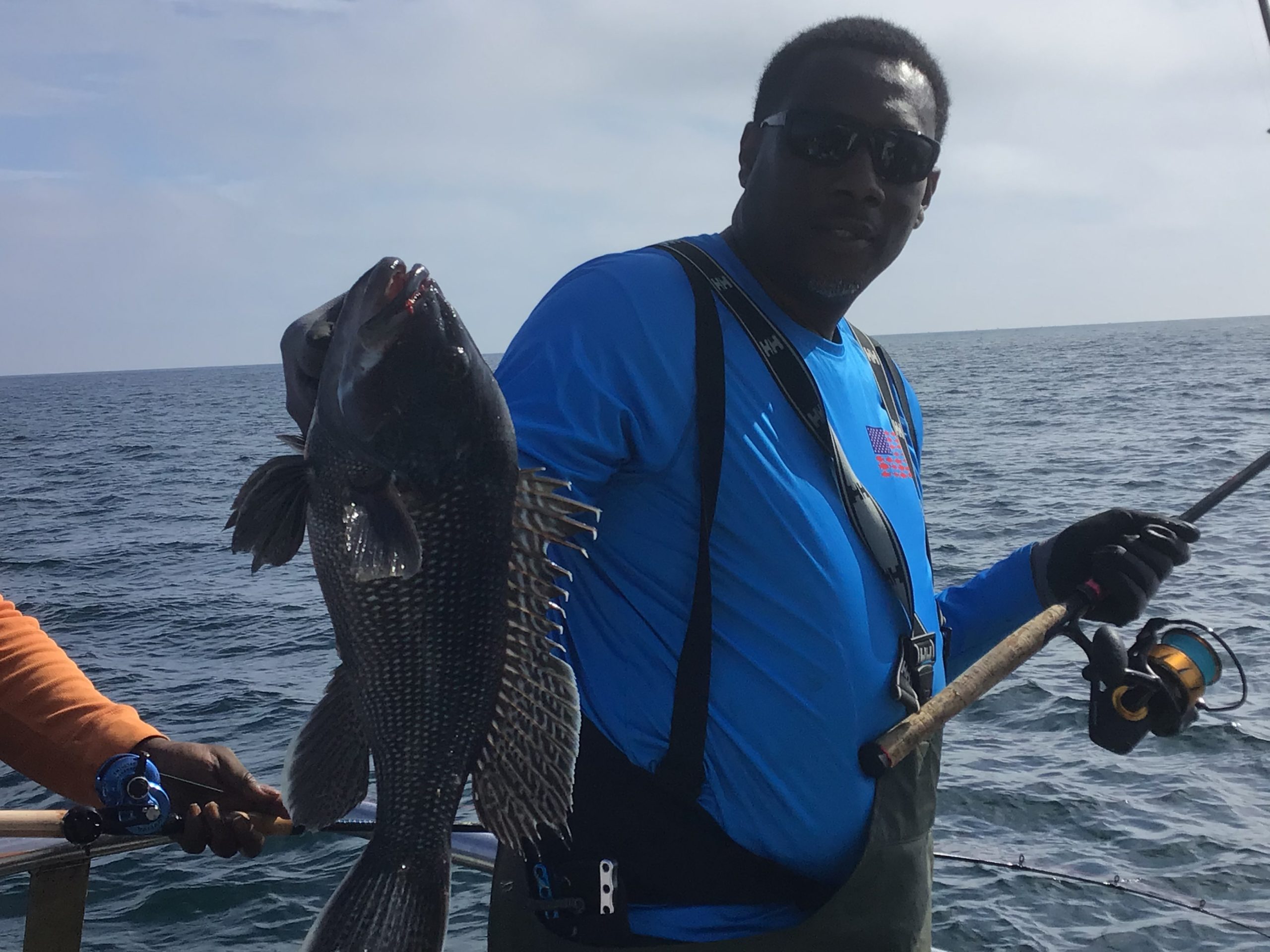 a person standing next to a body of water